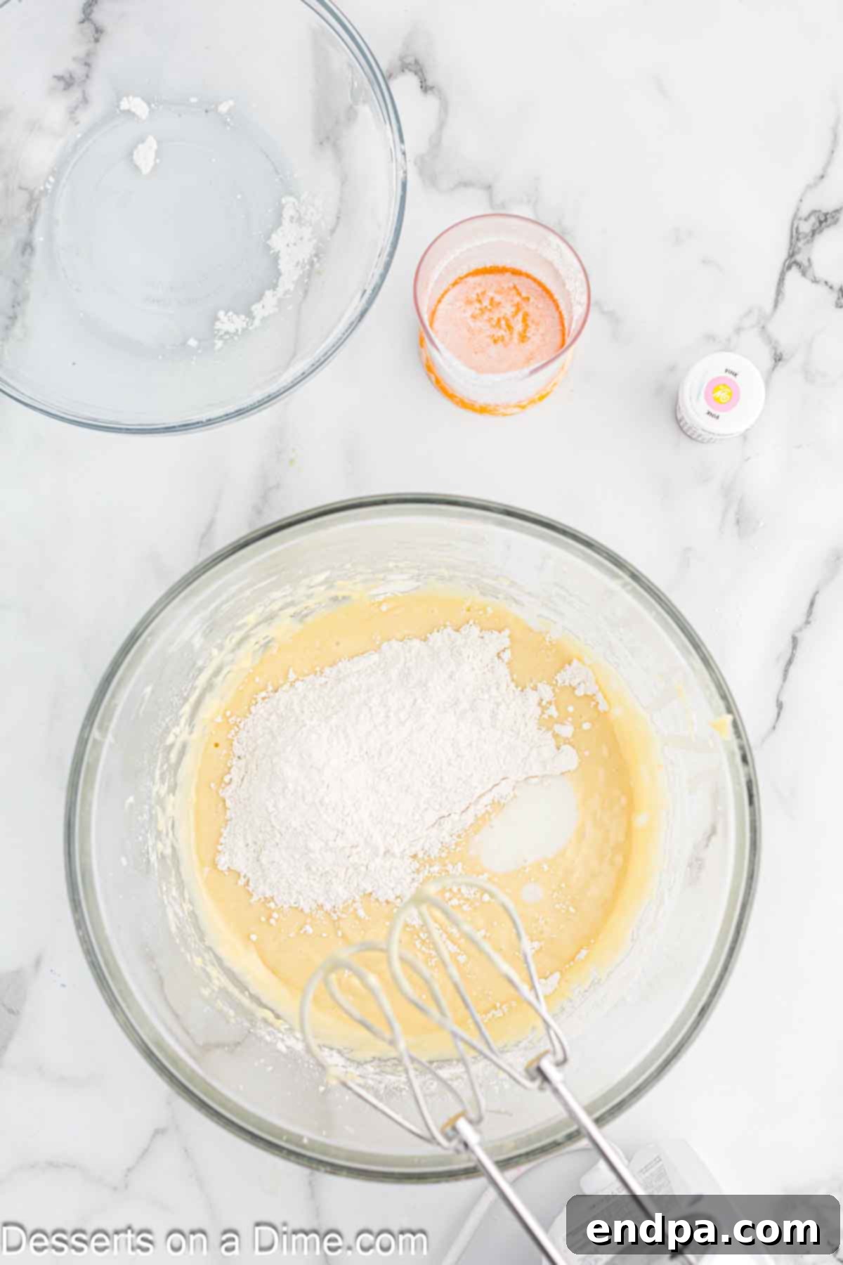 Dry ingredients and buttermilk being gradually added and combined with the wet mixture in a large mixing bowl.