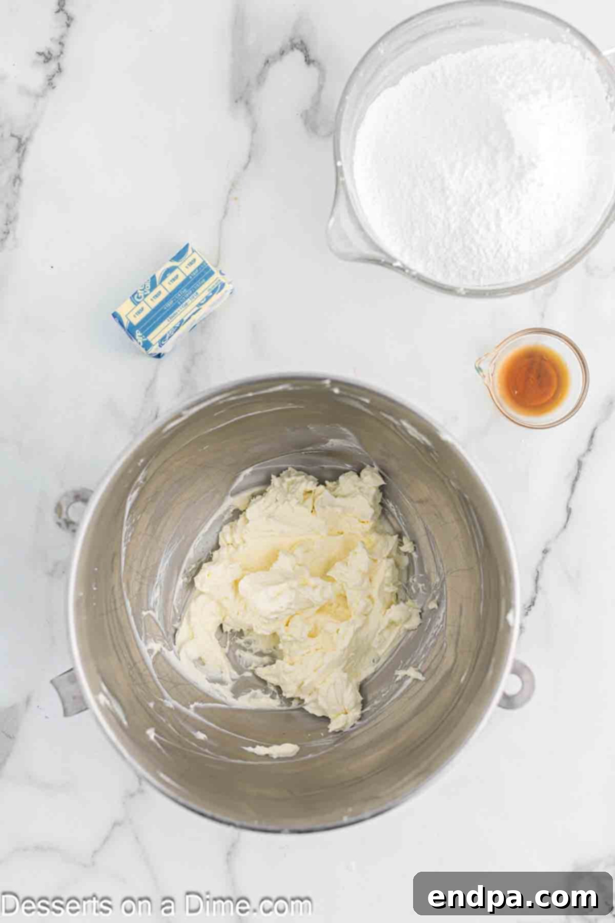 Softened cream cheese and butter in a separate bowl, ready to be beaten for the frosting.