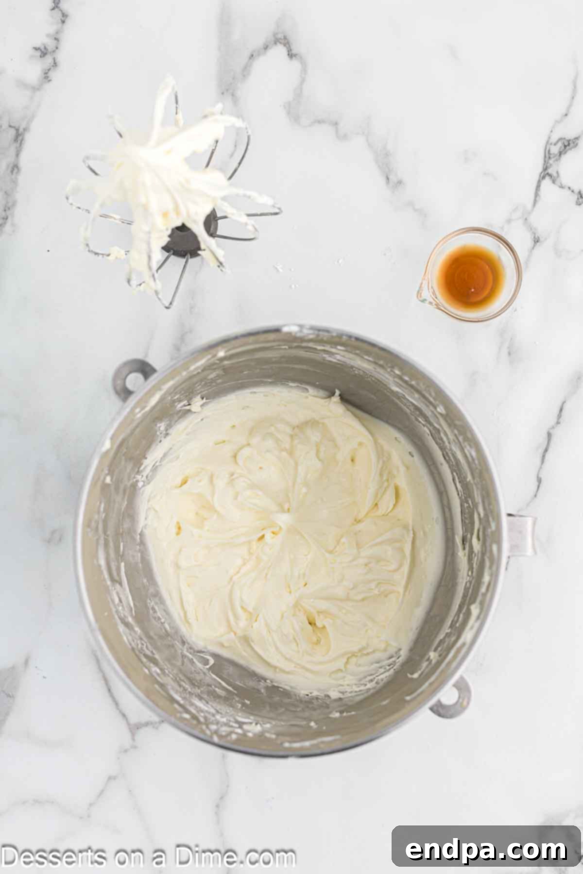 Powdered sugar being gradually added to the cream cheese and butter mixture for frosting.