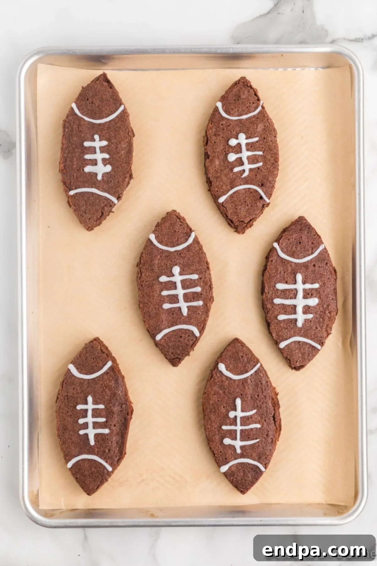 Laces piped on to the football brownie with white icing. 