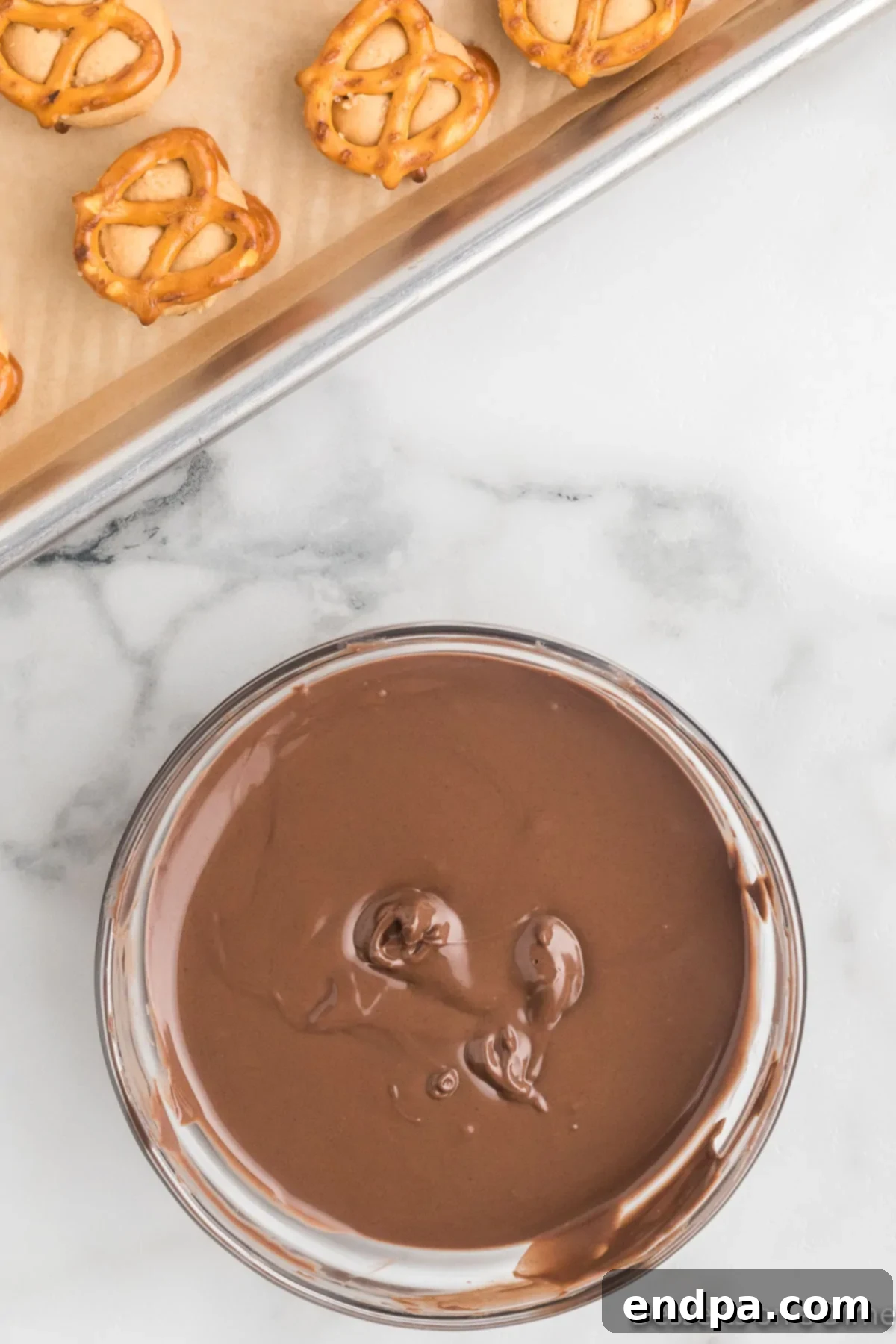 A bowl of smooth, glossy melted chocolate, ready for dipping.