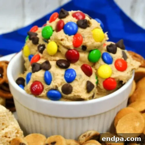 Monster M&Ms Chocolate Chip Cookie Dough Dip loaded with M&M's, chocolate chips, and oatmeal.