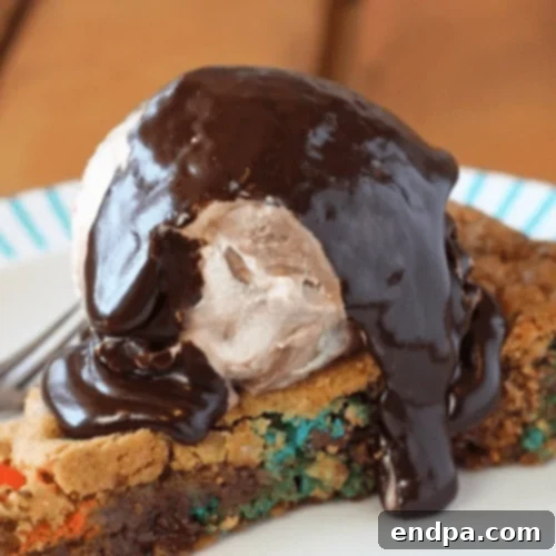 Giant M&M Skillet Cookie baked in a cast iron skillet, loaded with mix-ins.