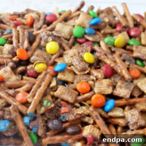 Sweet and salty Chex Mix Bars with pretzels and M&M's for a crunchy, no-bake snack.