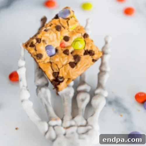 Festive Halloween M&M Cookie Bars loaded with holiday M&M's and mini chocolate chips.