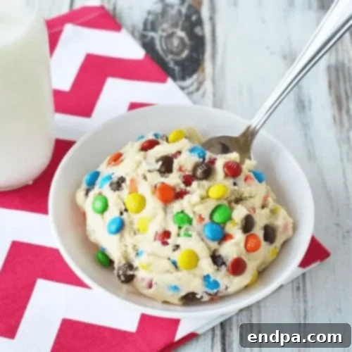 Safe-to-eat No-Bake Cookie Dough with M&M Candies, perfect as a dip or by the spoonful.