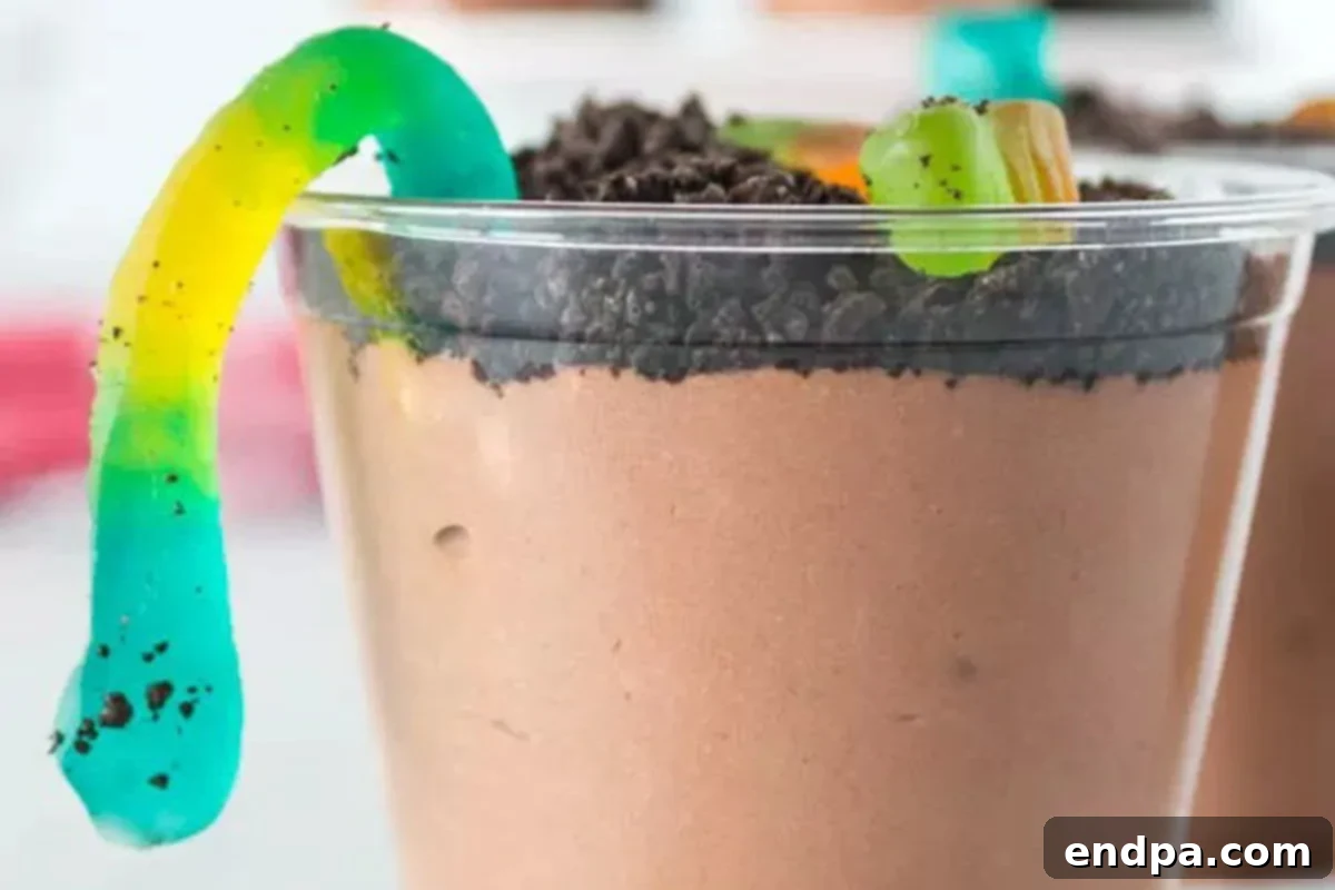 Delicious Dirt Cup Delight 2 Delicious Dirt Pudding Cup topped with generous crushed Oreo cookies and vibrant gummy worms, ready to be enjoyed.