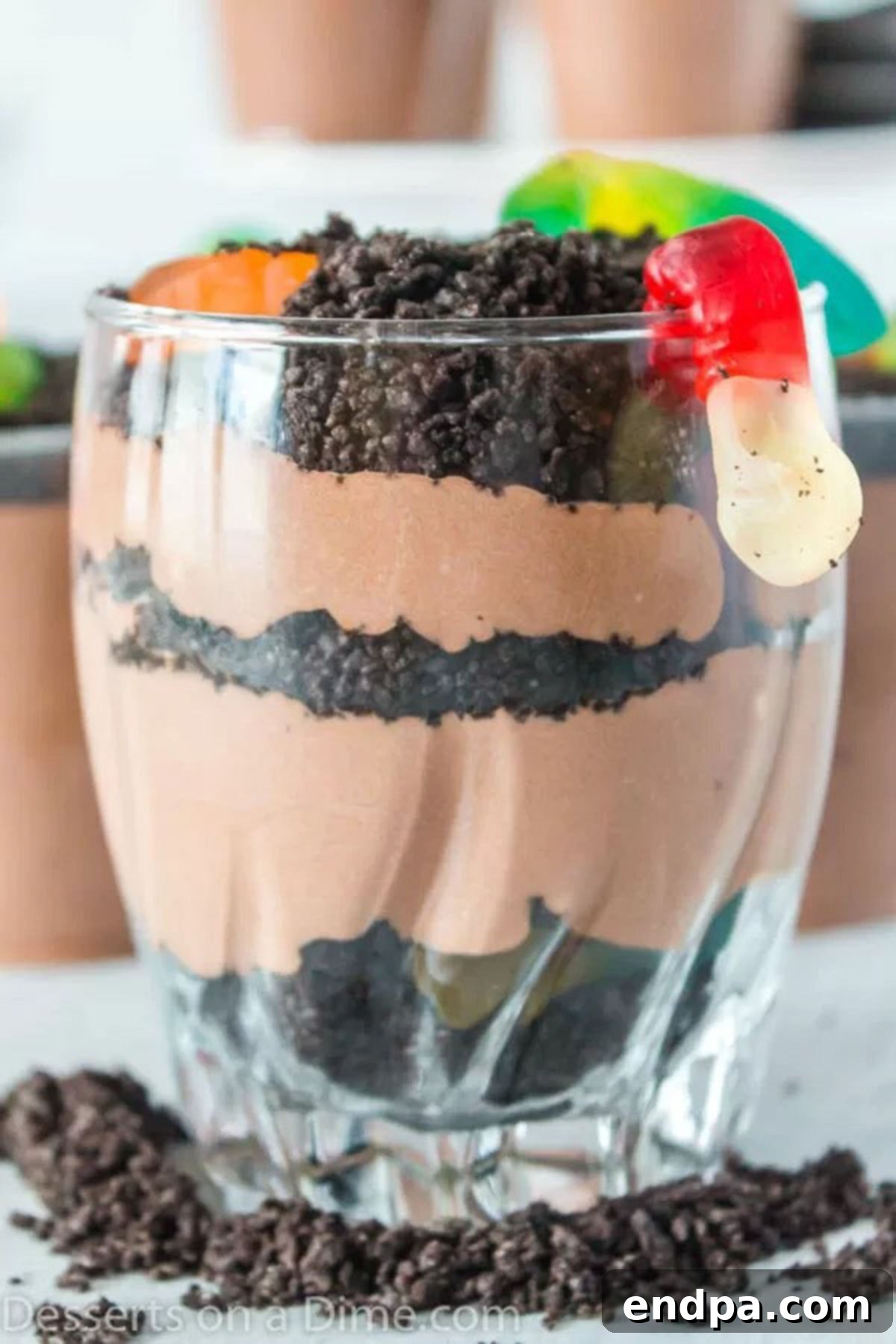 Delicious Dirt Cup Delight 6 Individual Dirt Cups layered with chocolate pudding and crushed Oreos, topped with gummy worms.