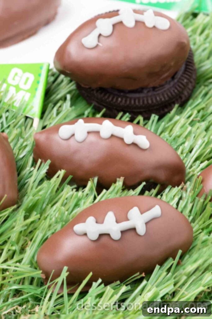 Festive Football Shaped Oreo Balls on faux grass, arranged for a Game Day party.