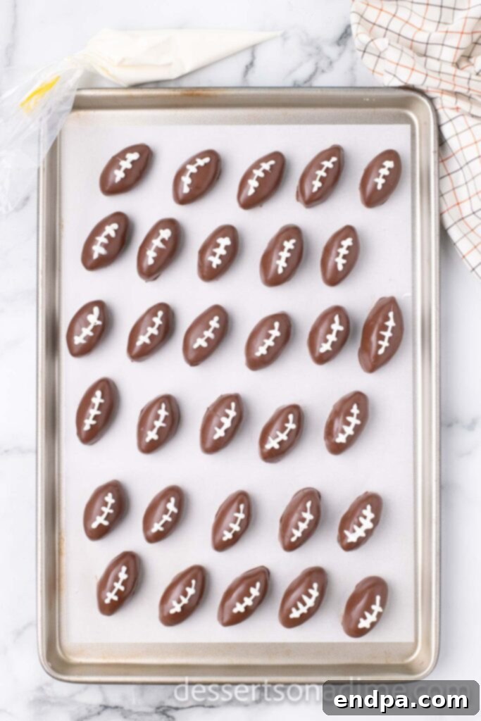 Football Oreo Balls with white chocolate laces drawn on them.