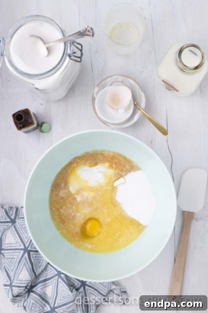 Heavenly Snickerdoodle Cupcakes 5 Combining the butter with eggs, sugar, sour cream, milk and vailla extract