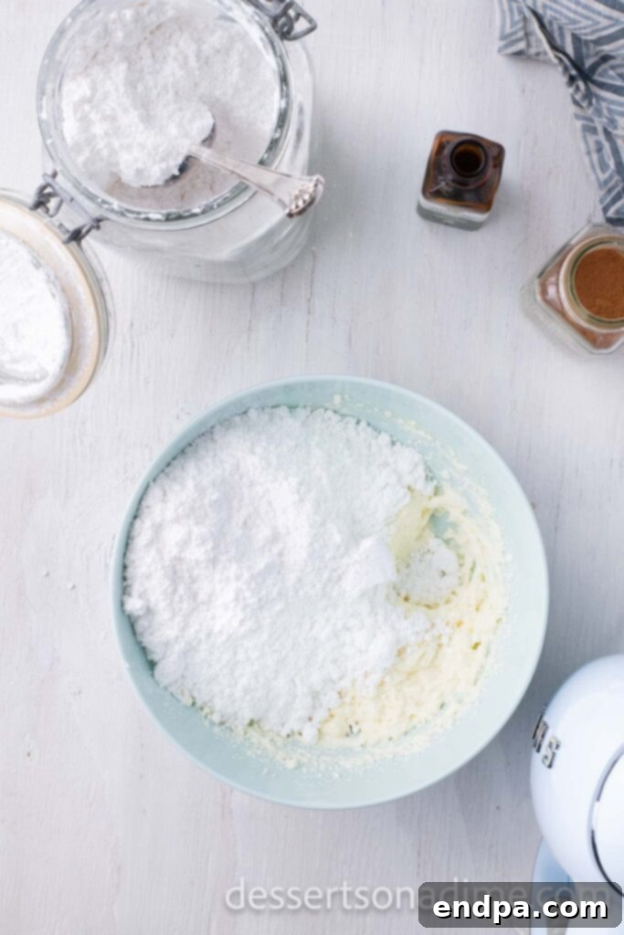 Heavenly Snickerdoodle Cupcakes 10 Adding powdered sugar to the cream cheese mixture