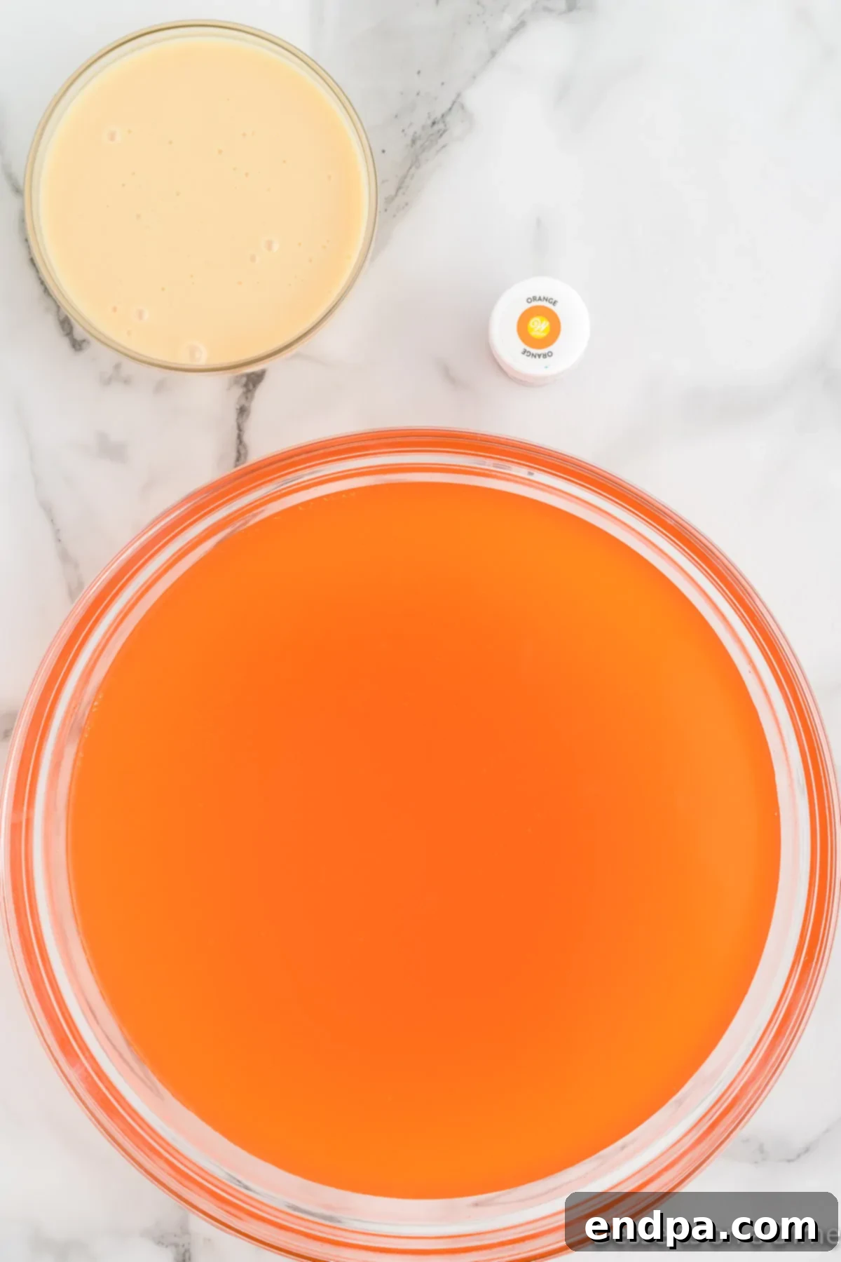 Sunset Swirl 4 Large mixing bowl with orange soda poured in, allowing the bubbles to settle.