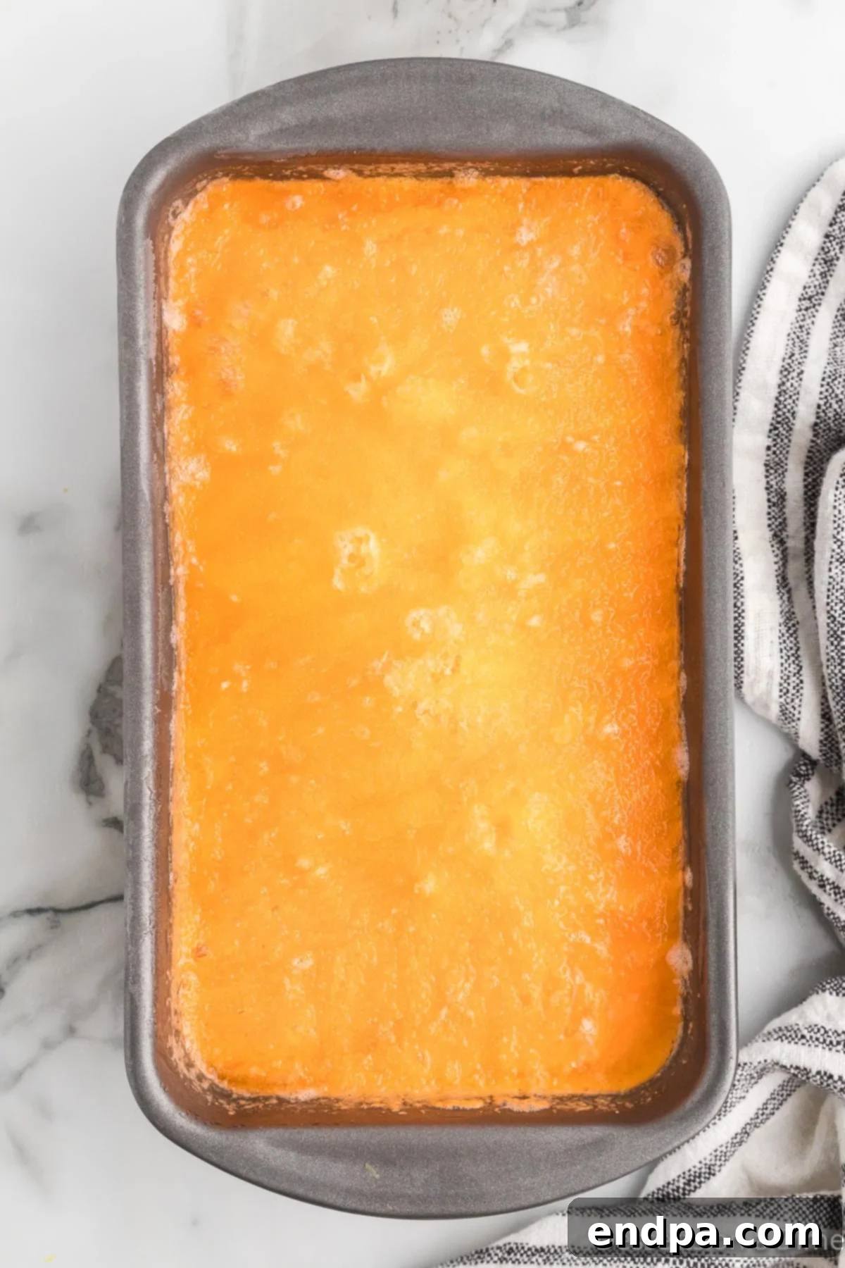 Sunset Swirl 7 Frozen orange sherbet scooped into a serving dish, ready to be enjoyed.