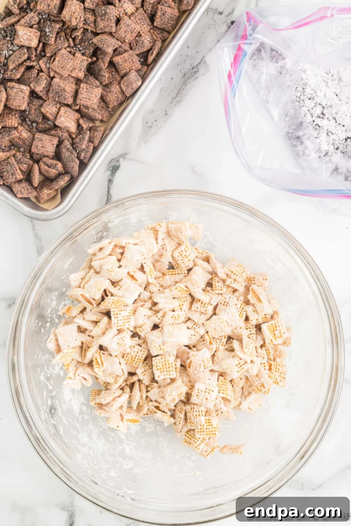 Chex cereal coated evenly in the melted white chocolate mixture.