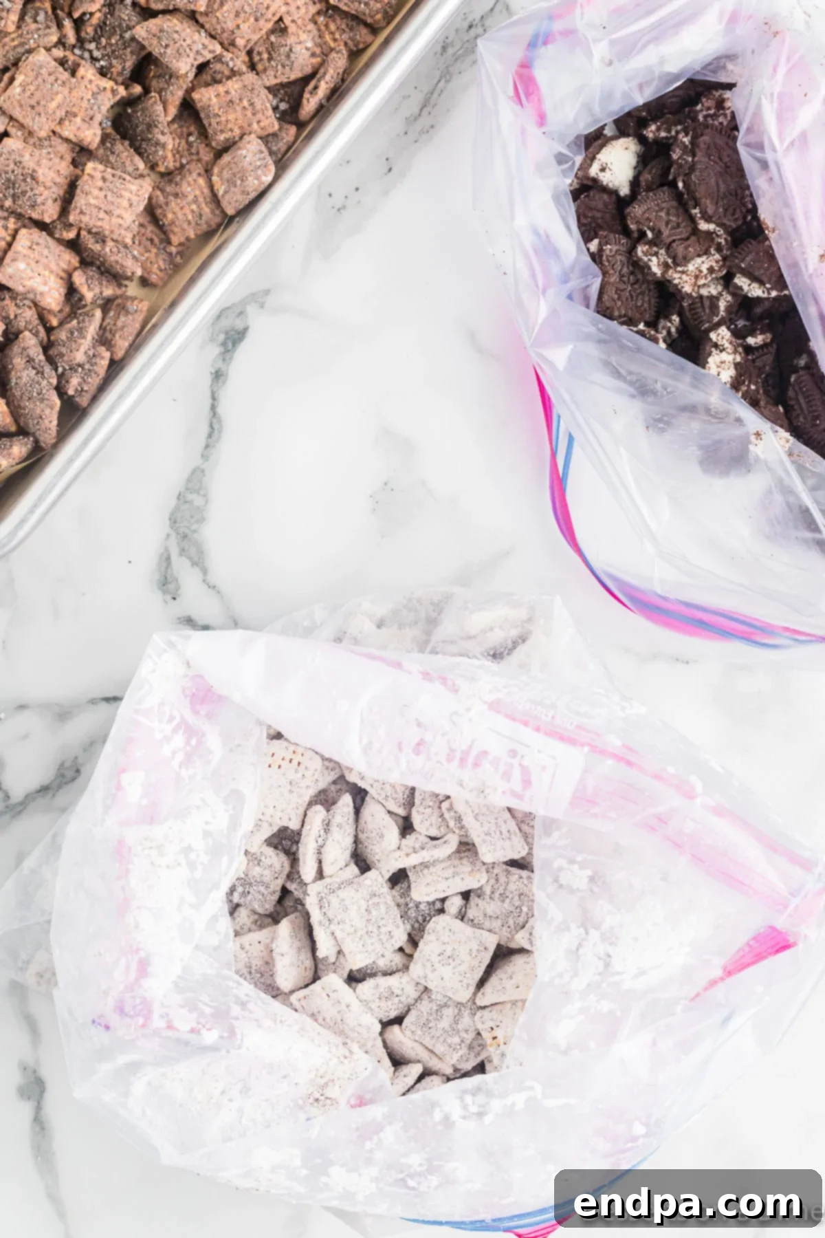 Two ziplock bags, one containing white chocolate coated cereal and powdered sugar, the other with milk chocolate coated cereal and powdered sugar, ready for shaking.