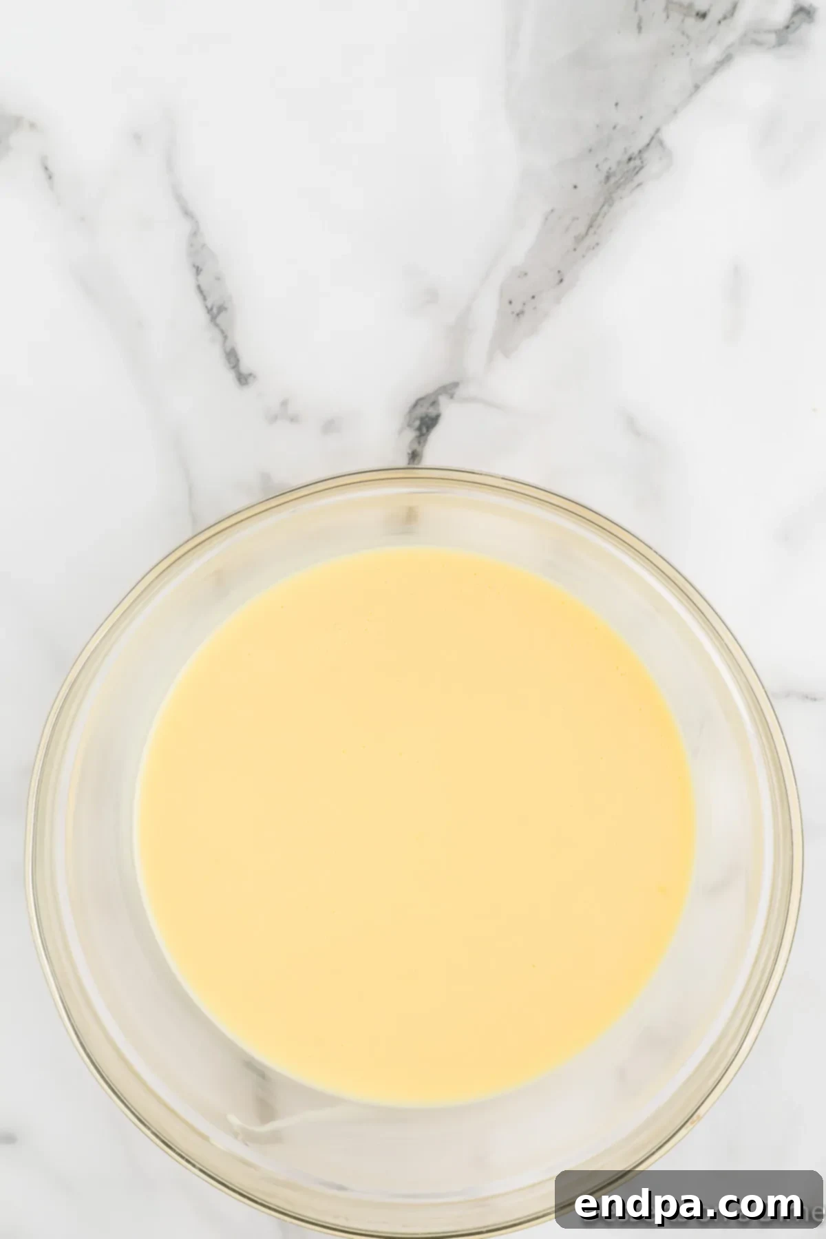 Homemade Magnolia Bakery Banana Pudding Perfection 4 Large glass bowl with creamy pudding mixture, showing its smooth texture before chilling.