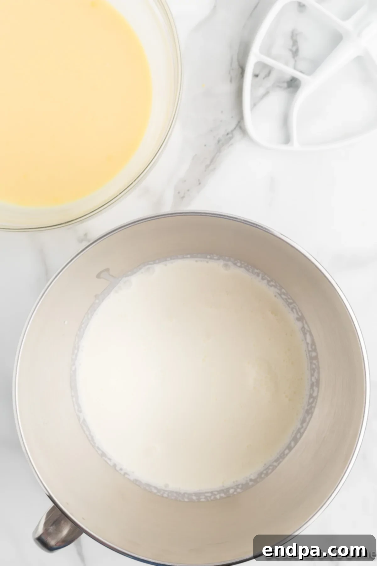 Homemade Magnolia Bakery Banana Pudding Perfection 5 Bowl of freshly whipped heavy cream, showing stiff peaks.