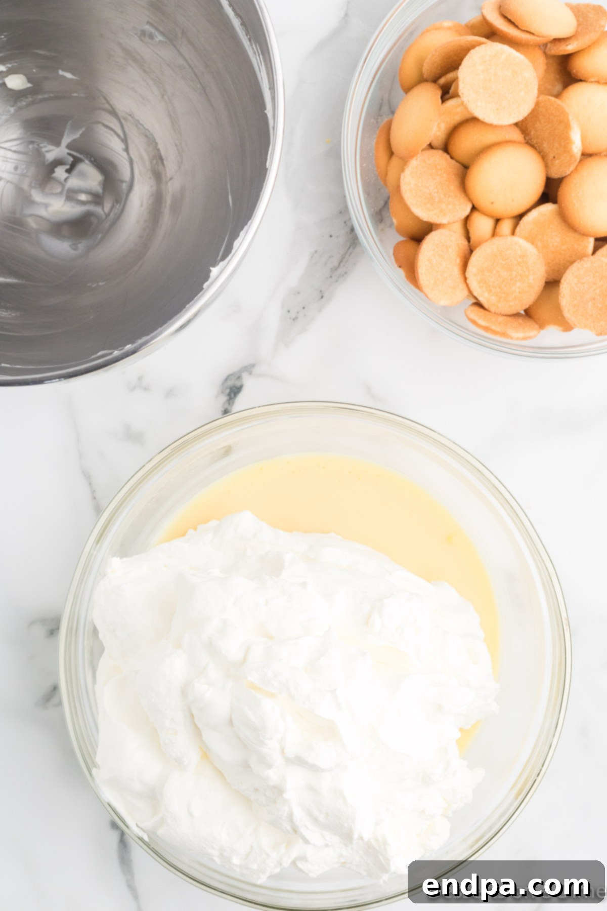 Homemade Magnolia Bakery Banana Pudding Perfection 6 The whipped cream being gently folded into the thickened pudding mixture.