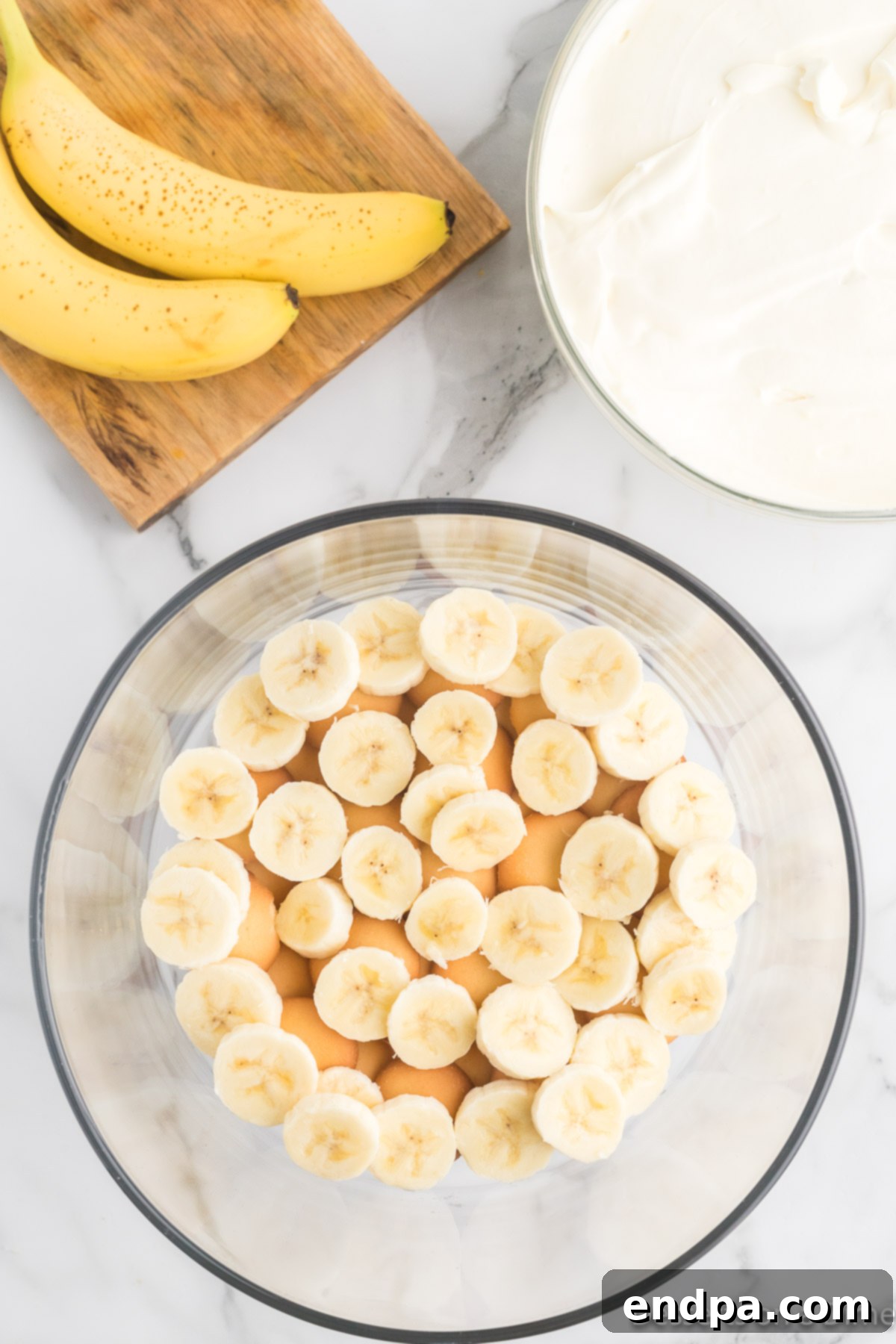 Homemade Magnolia Bakery Banana Pudding Perfection 8 Sliced barely ripe bananas placed on top of the vanilla wafers layer.