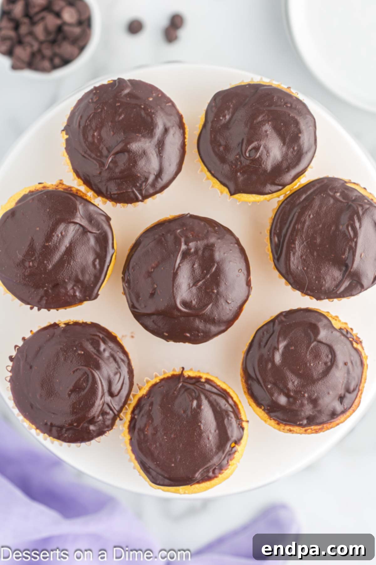 Gourmet Eclair Cupcakes 12 A full platter of exquisite Chocolate Eclair Cupcakes, perfectly arranged and ready to be served at an event or gathering.