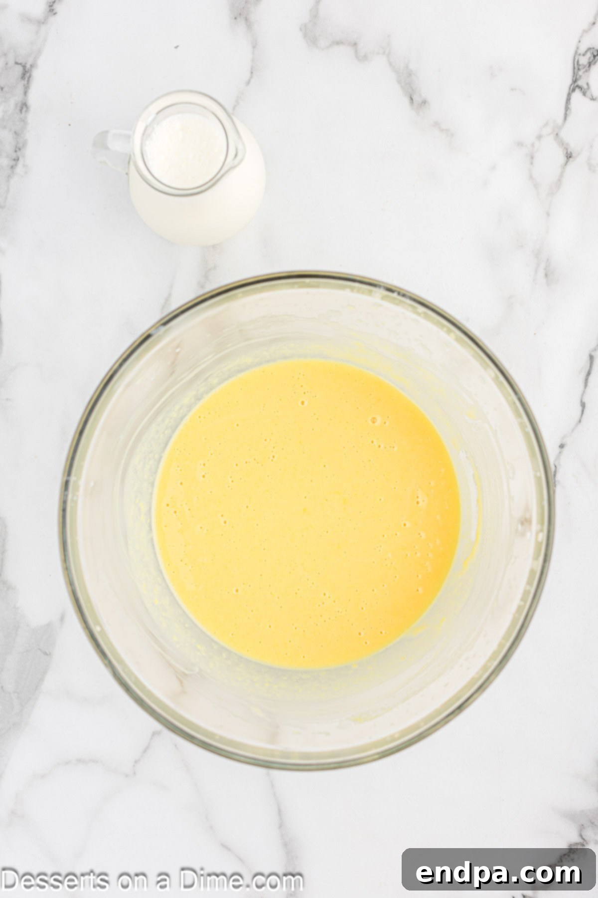 Gourmet Eclair Cupcakes 4 A bowl containing a smooth, creamy, pale yellow pudding mixture, ready for the next step in preparing the Eclair Cupcake filling.