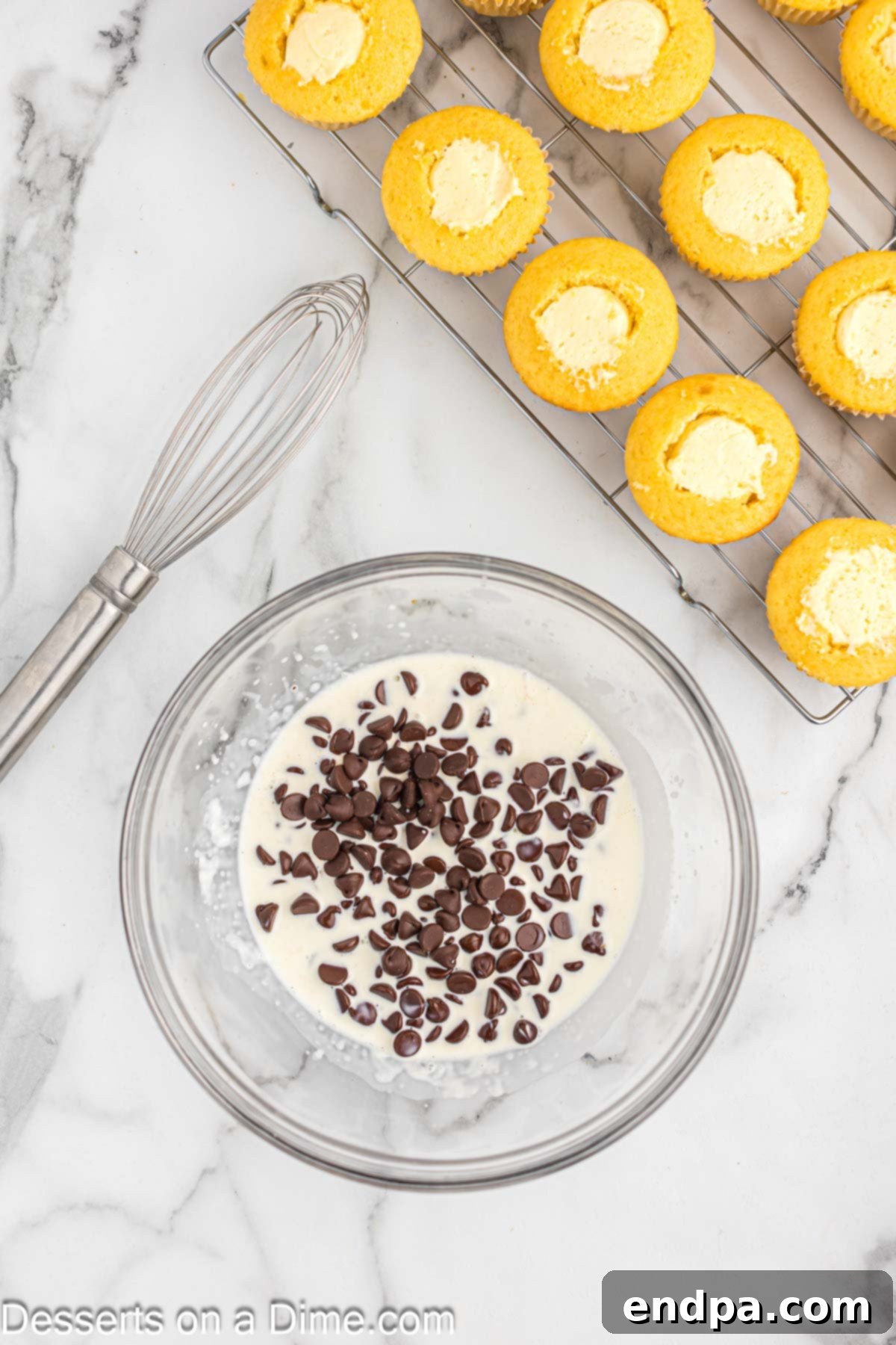 Gourmet Eclair Cupcakes 9 A microwave-safe bowl containing semi-sweet chocolate chips and heavy cream, prepared for making chocolate ganache.