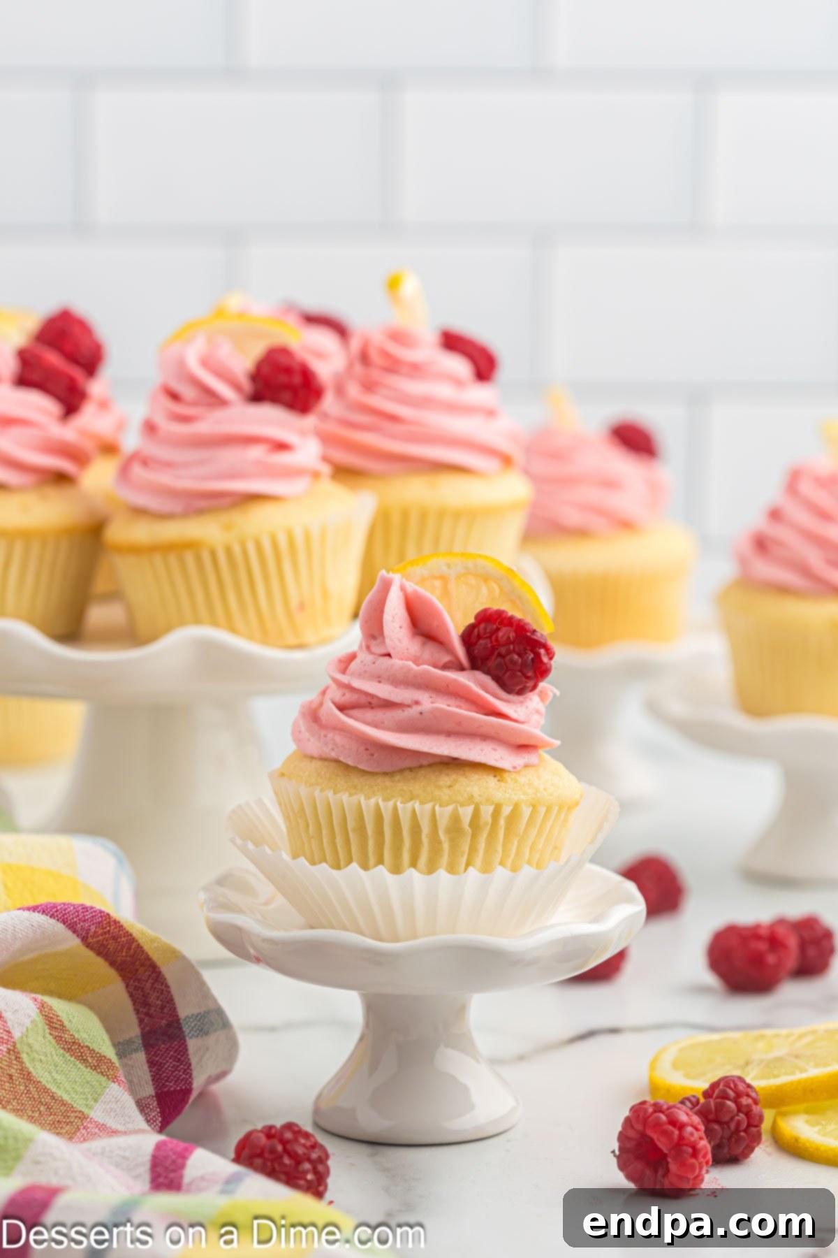 Zesty Lemon Raspberry Cupcakes 2 Lemon raspberry cupcakes on platter.