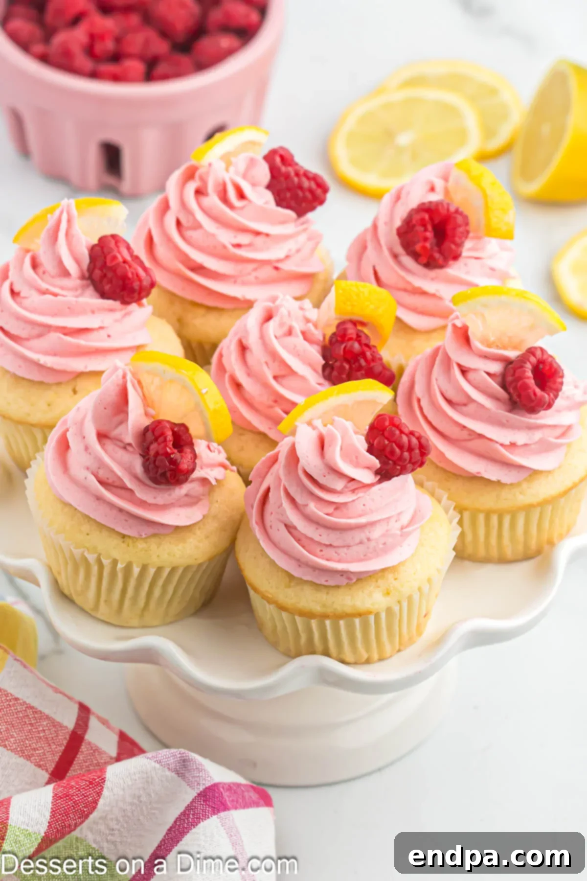 Zesty Lemon Raspberry Cupcakes 11 Lemon raspberry cupcakes on platter.