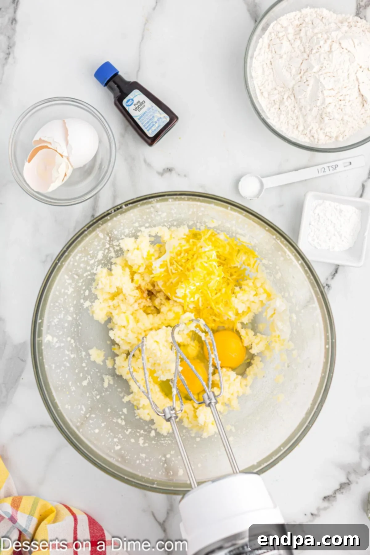 Zesty Lemon Raspberry Cupcakes 5 Mixing bowl with eggs and sour cream added.