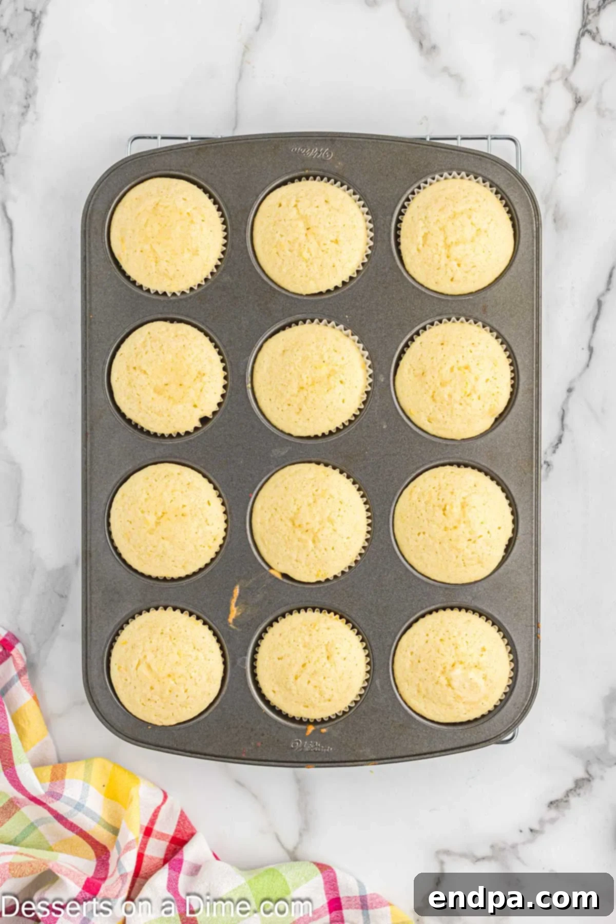 Zesty Lemon Raspberry Cupcakes 7 Cupcakes baked and cooling in muffin tin.