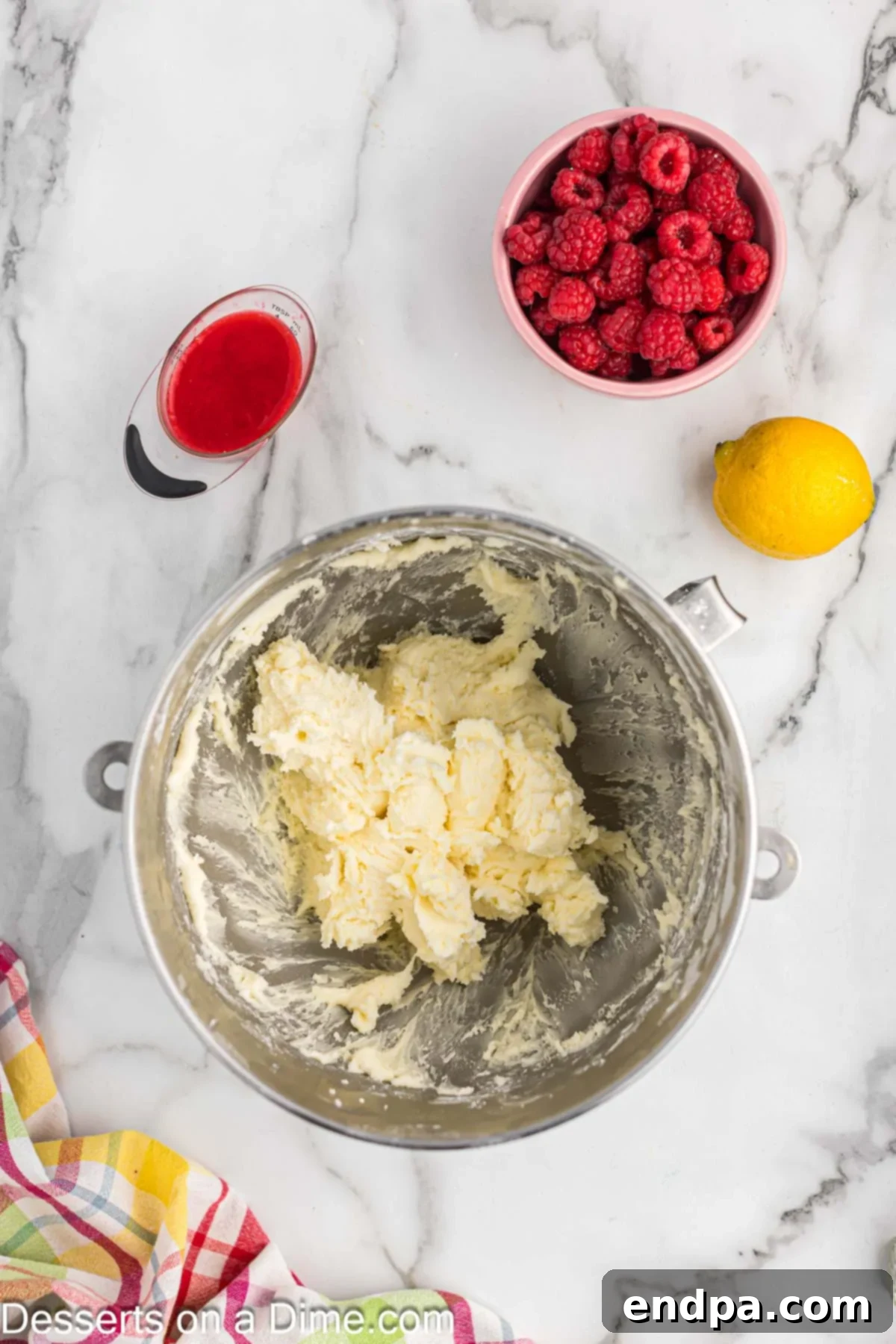 Zesty Lemon Raspberry Cupcakes 9 Mixing bowl with butter and powdered sugar combined.