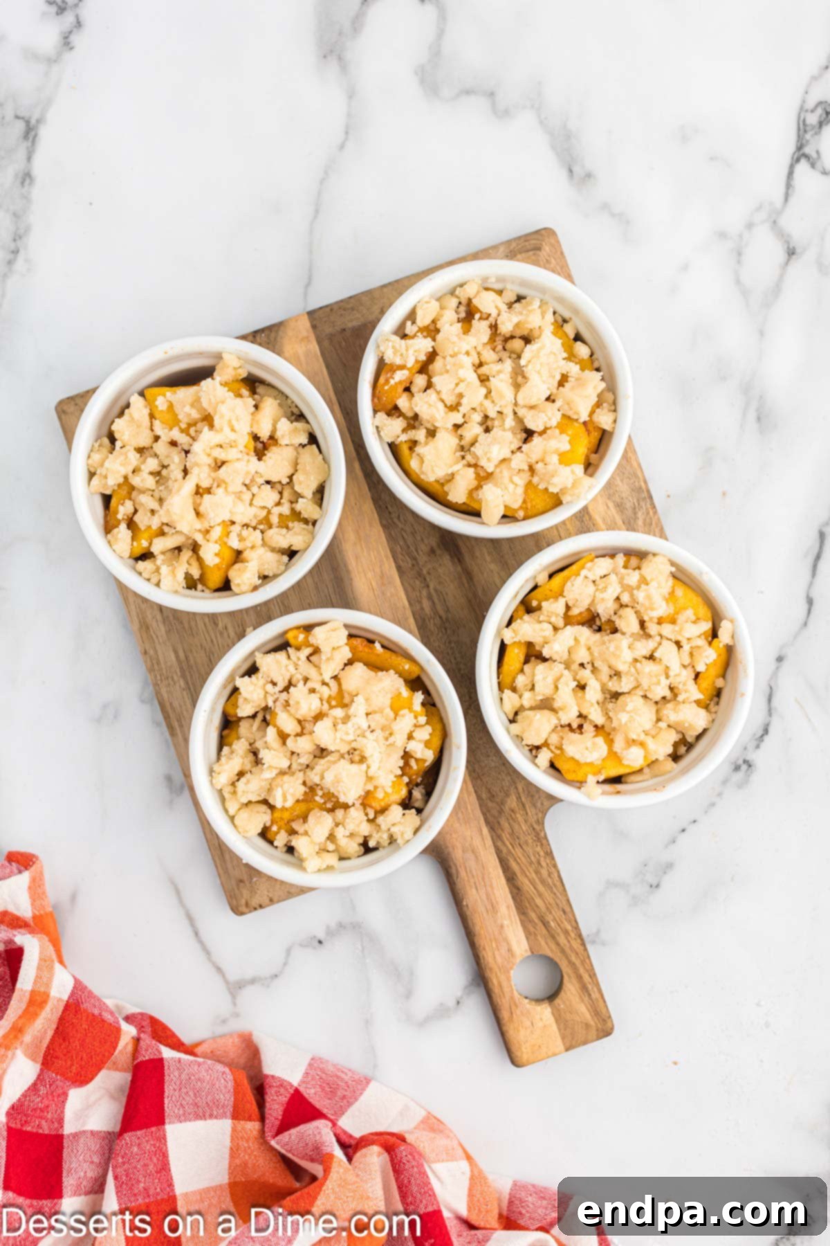 Topping the peach mixture with the biscuit topping