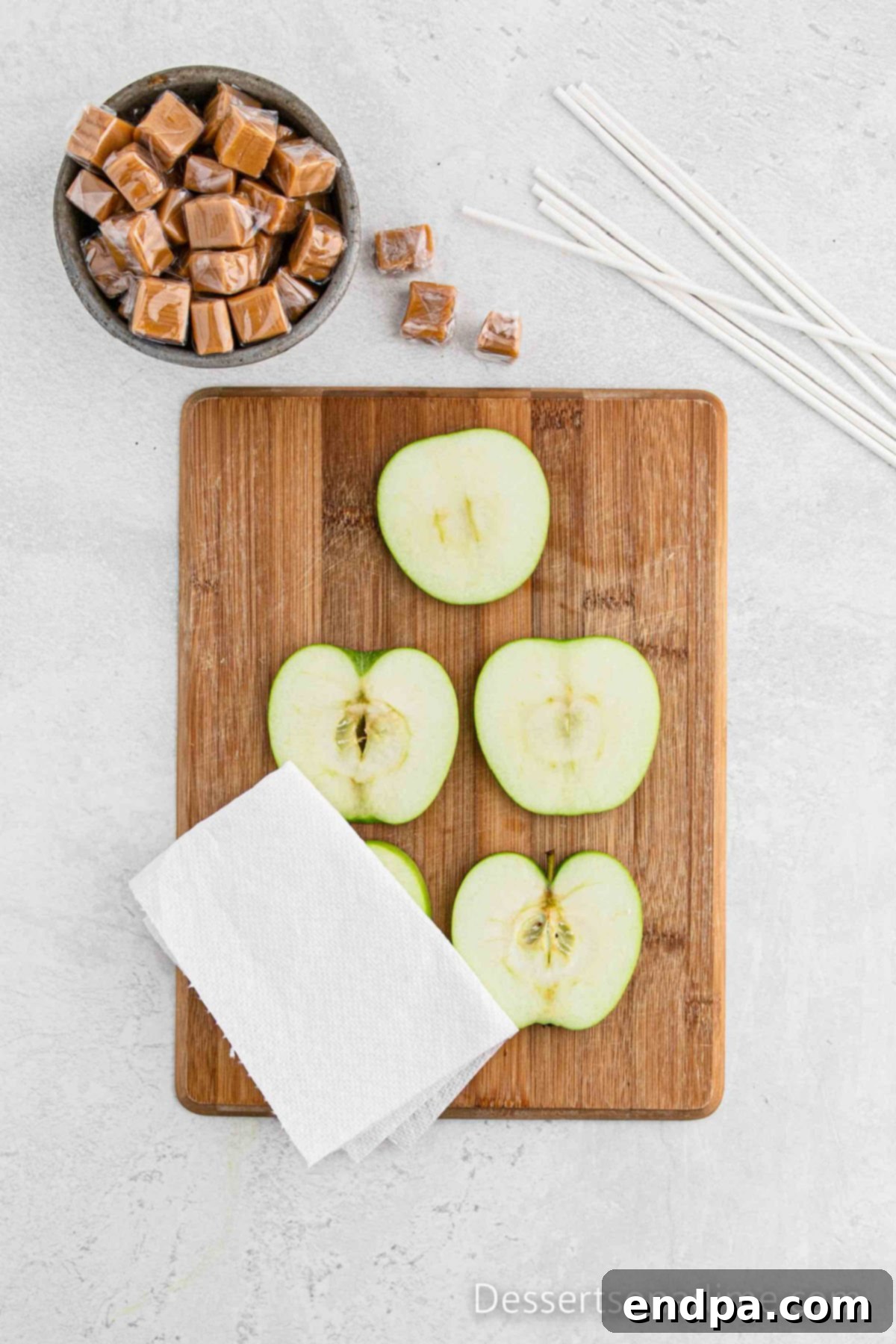 Paper towel on apples drying each slice.