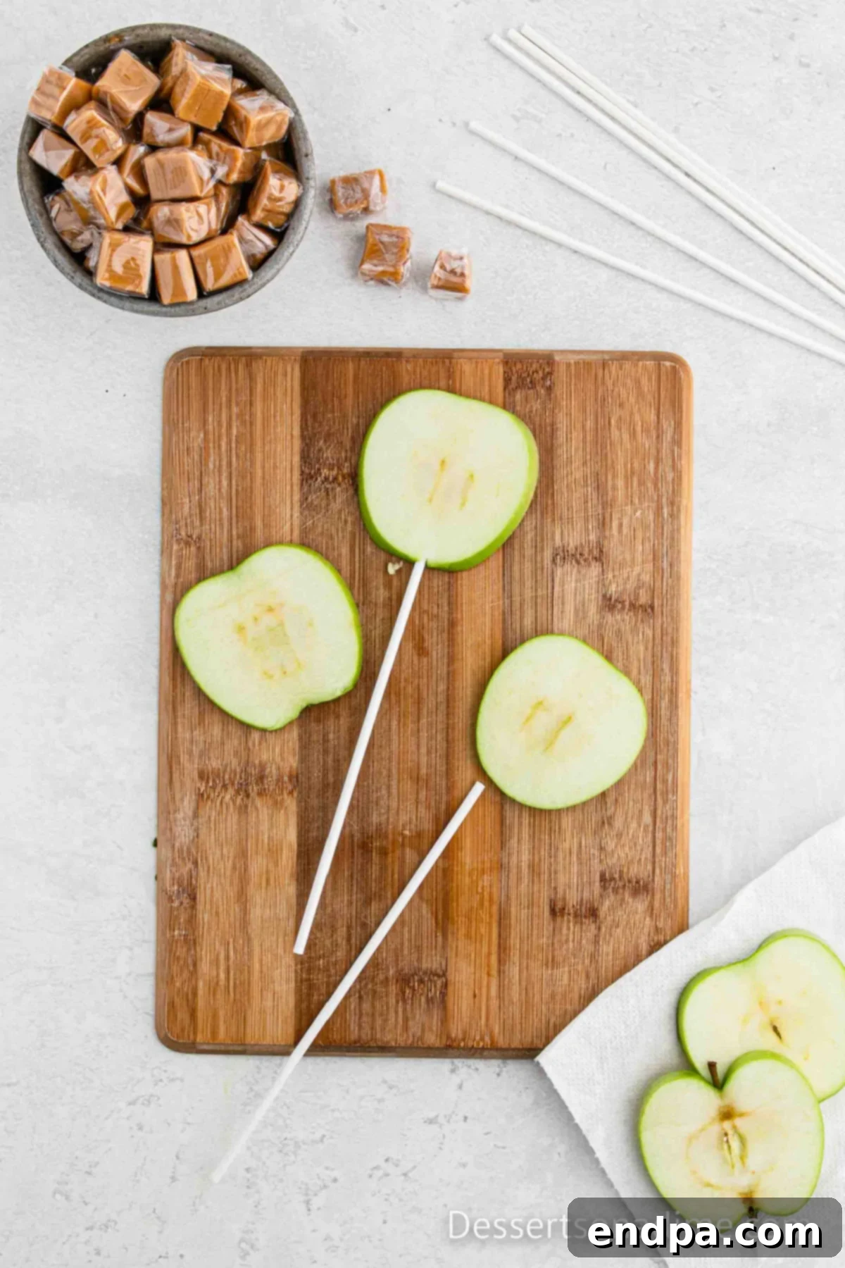 Lollipop stick going into the apples.