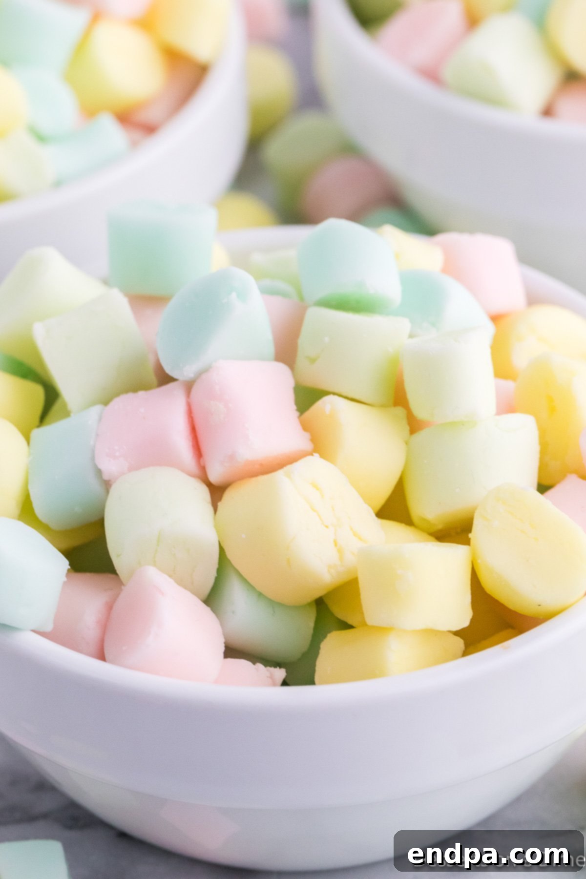 Creamy Mint Delights 2 Bowl of butter mints in various pastel colors ready to serve, showcasing their smooth, inviting texture.