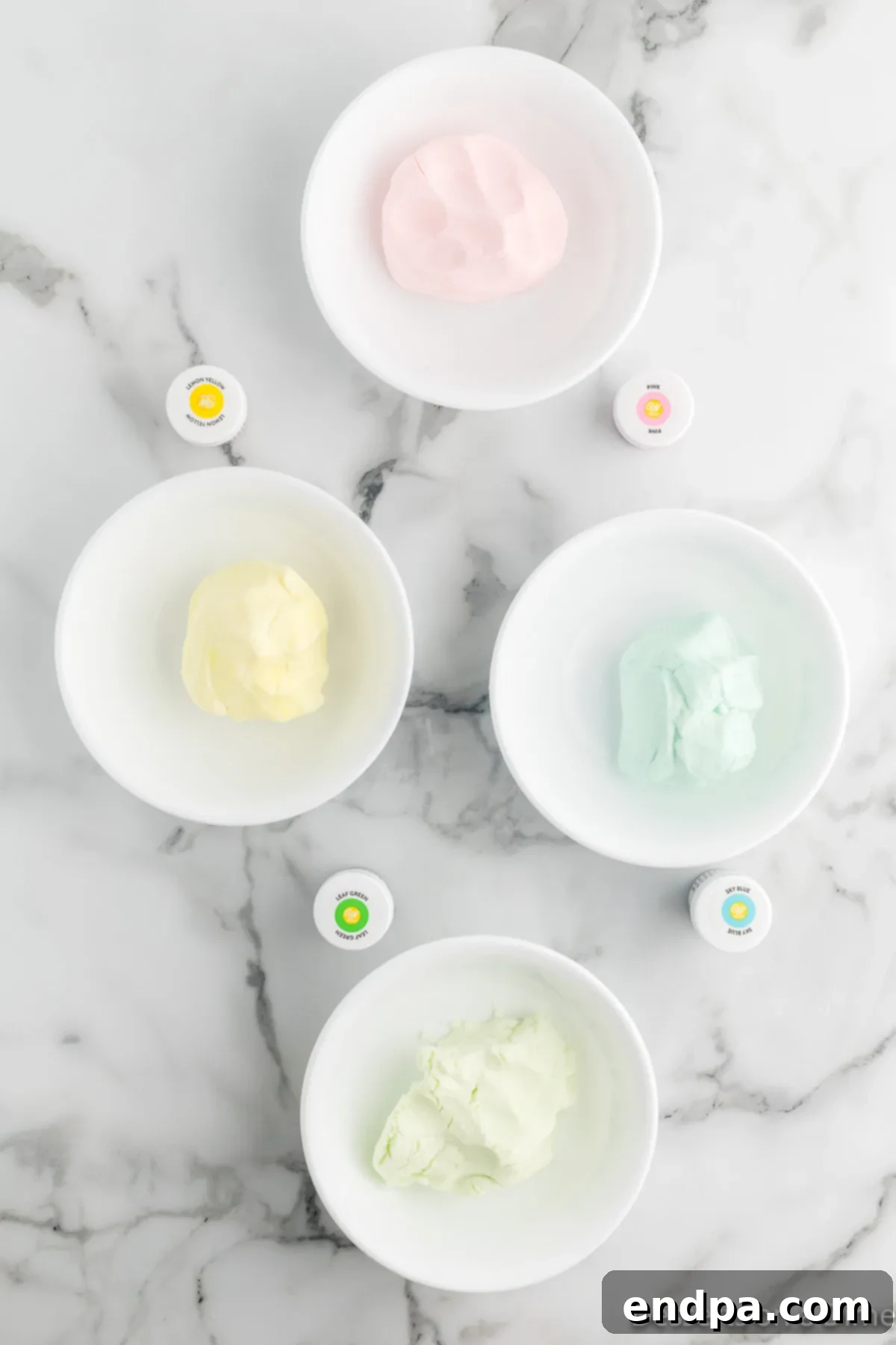 Creamy Mint Delights 6 Multiple bowls containing portions of butter mint dough, each dyed with a different vibrant food coloring (green, yellow, pink, blue).