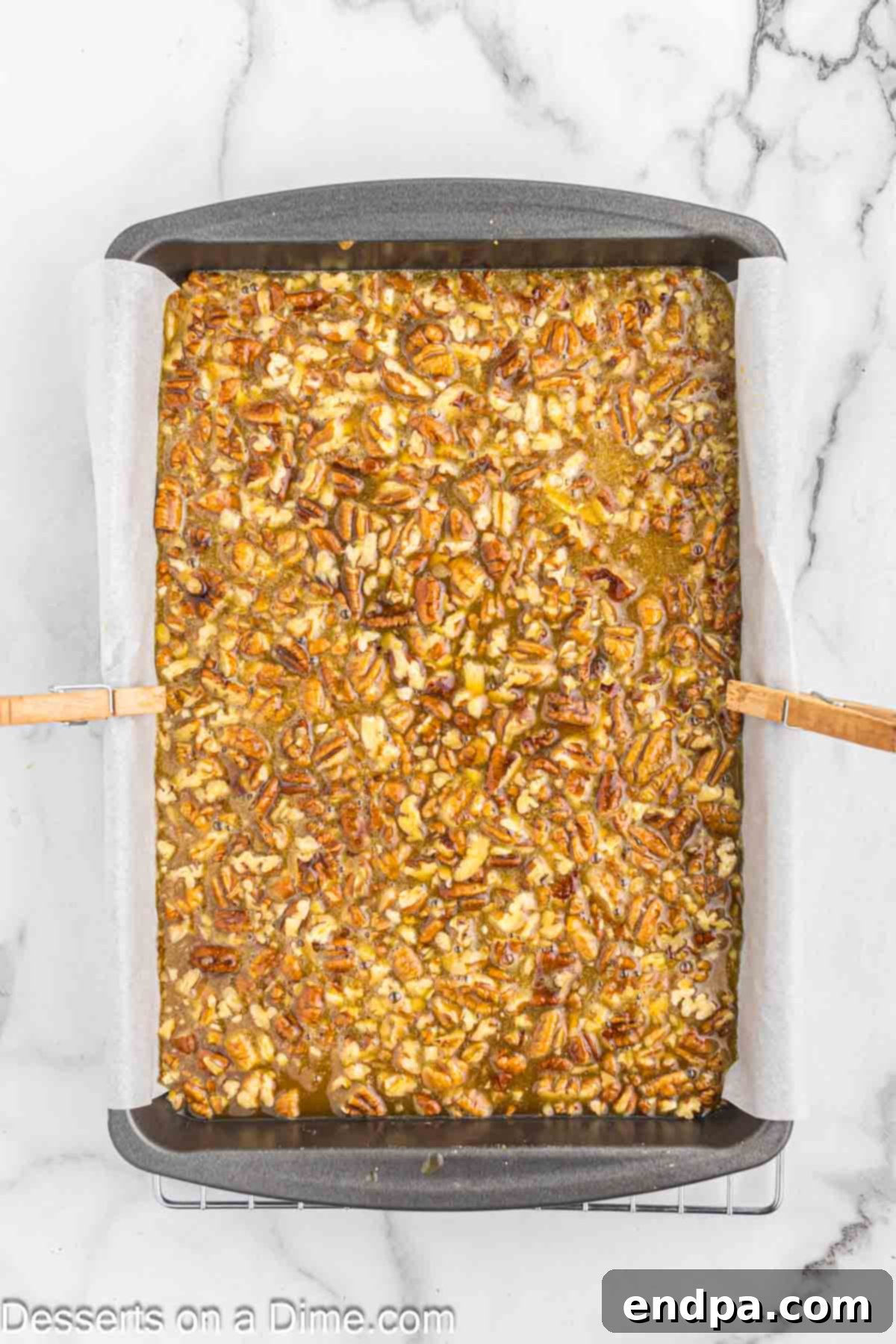 The rich, pecan-studded topping mixture being smoothly poured over the freshly pre-baked golden shortbread crust.