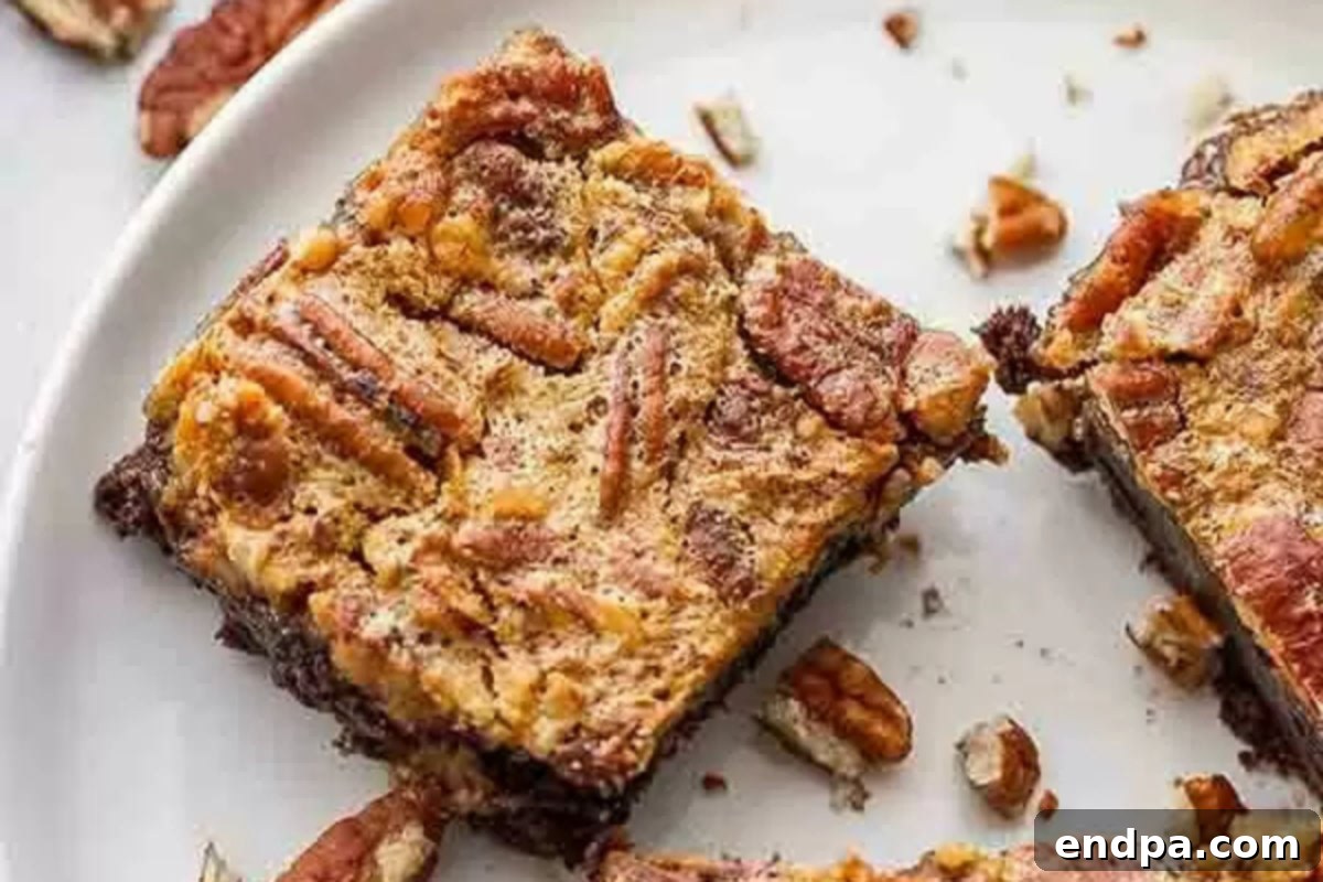 Pecan pie brownies cut and served on a white plate.