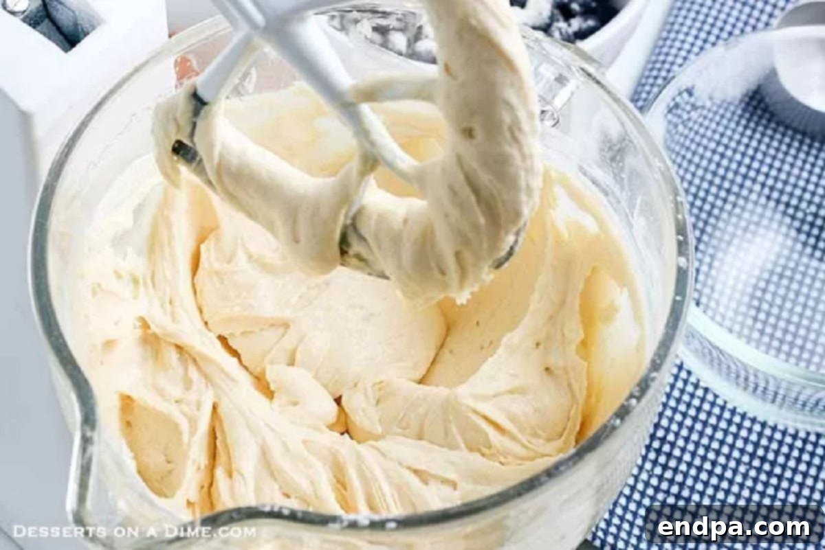 A mixing bowl filled with combined wet and dry ingredients, illustrating the smooth, uniform consistency of the coffee cake batter before blueberries are added.