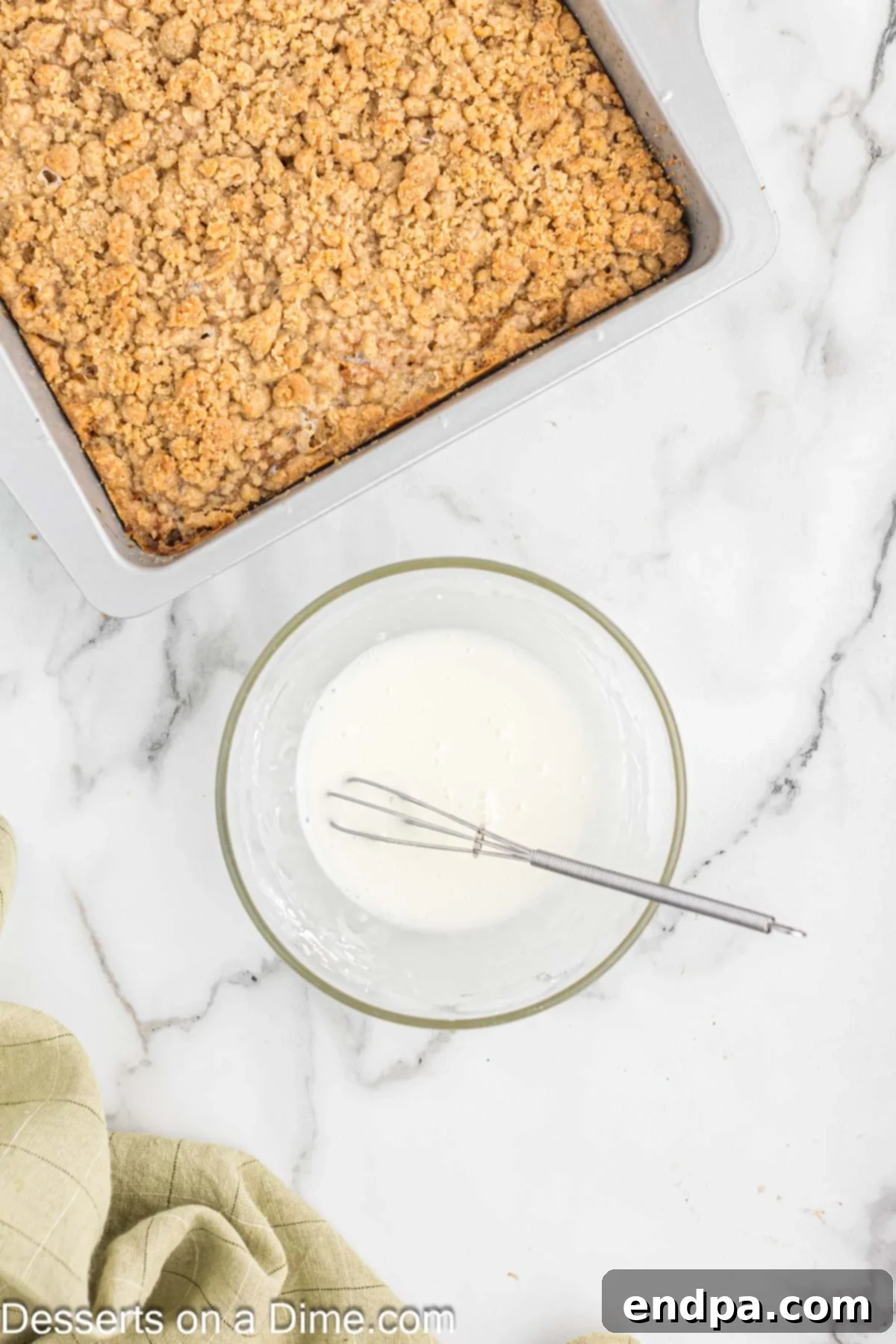 A small bowl holding the whisked vanilla glaze, showing its smooth, pourable consistency.