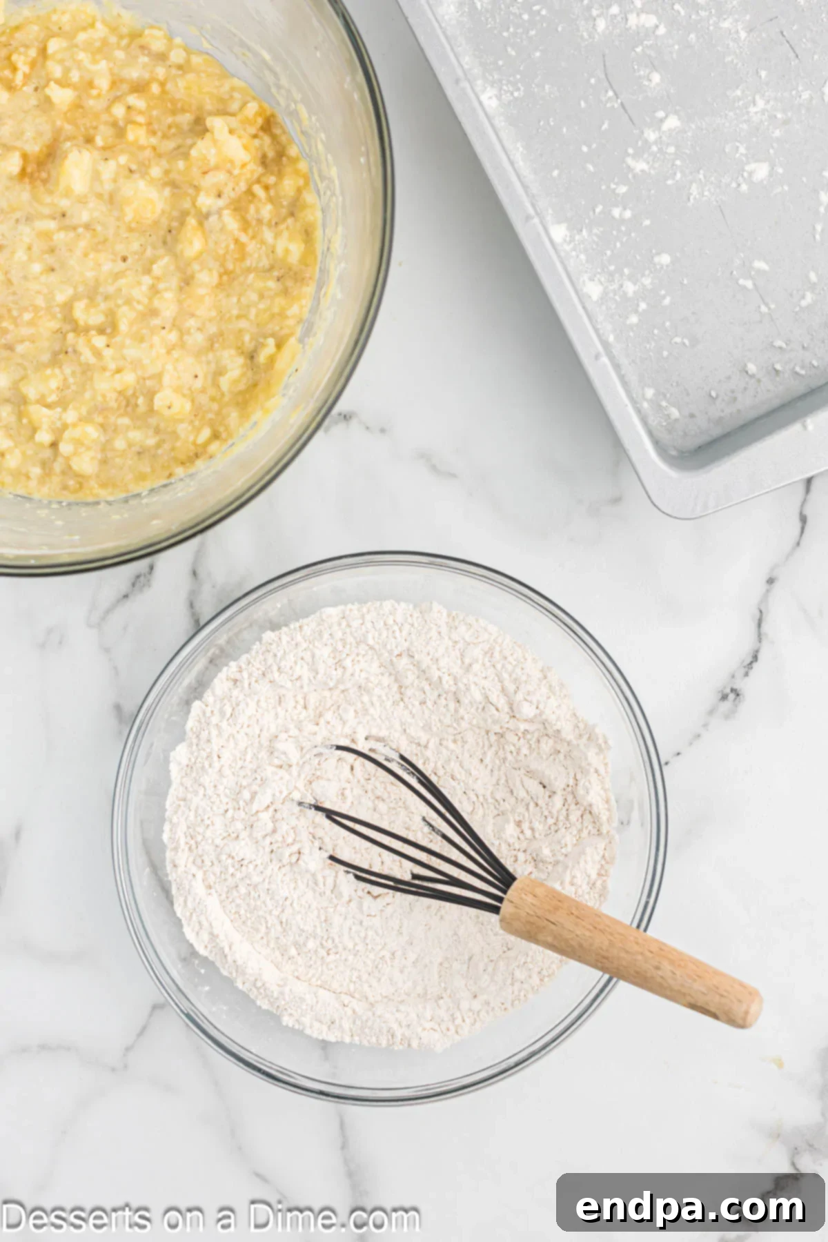 A separate mixing bowl holding the sifted dry ingredients for the coffee cake batter, including flour, baking powder, baking soda, salt, and cinnamon.