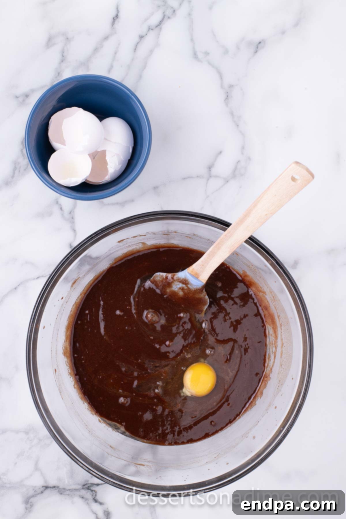 Decadent Reese's Peanut Butter Brownies 5 Melted chocolate mixture with eggs being incorporated.