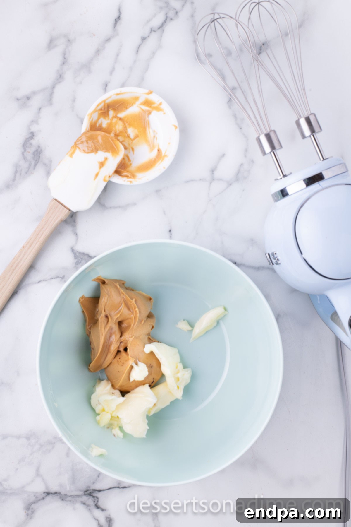 Decadent Reese's Peanut Butter Brownies 8 Mixing bowl with softened peanut butter and butter for frosting.