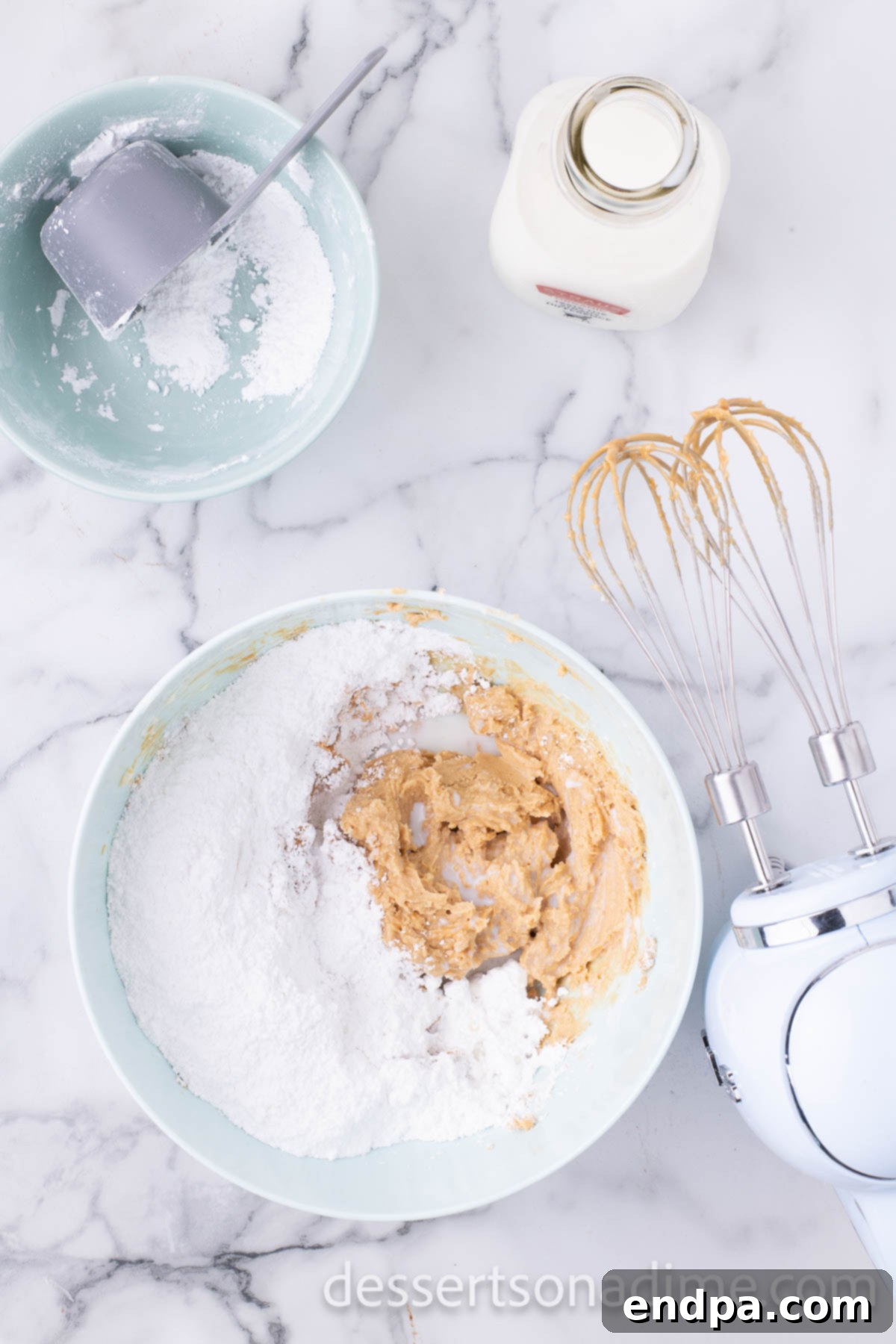 Decadent Reese's Peanut Butter Brownies 9 Powdered sugar being added to the peanut butter frosting mixture.