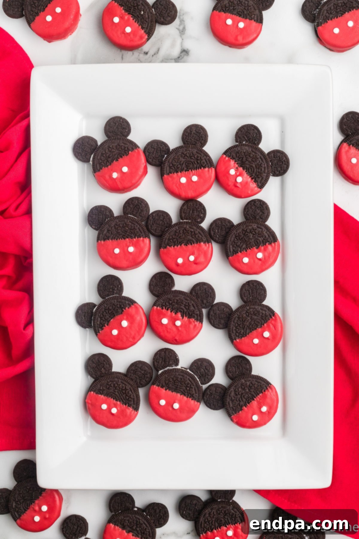 Mickey's Magical Oreo Treats 2 A platter filled with delightful Mickey Mouse Oreo Cookies, showcasing their iconic red bottoms and black ears, ready to be enjoyed.