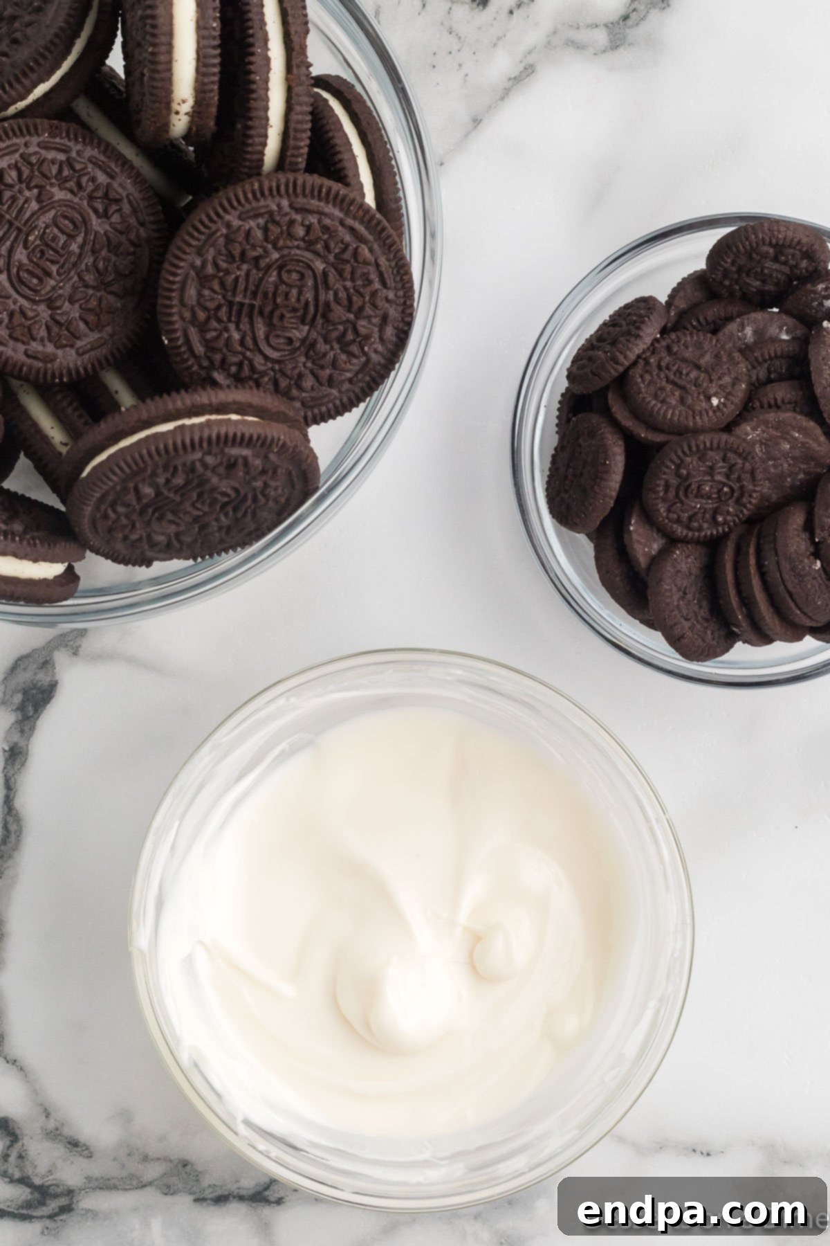 Mickey's Magical Oreo Treats 4 White candy melts in a microwave-safe bowl, freshly melted and perfectly smooth, ready for dipping.
