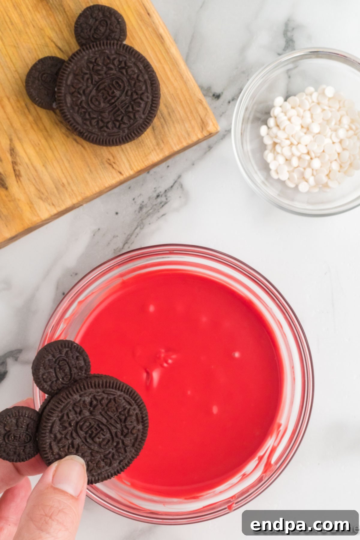 Mickey's Magical Oreo Treats 7 Red candy melts in a bowl, smoothly melted and vibrant, ready for dipping the Oreo cookies to create Mickey's shorts.