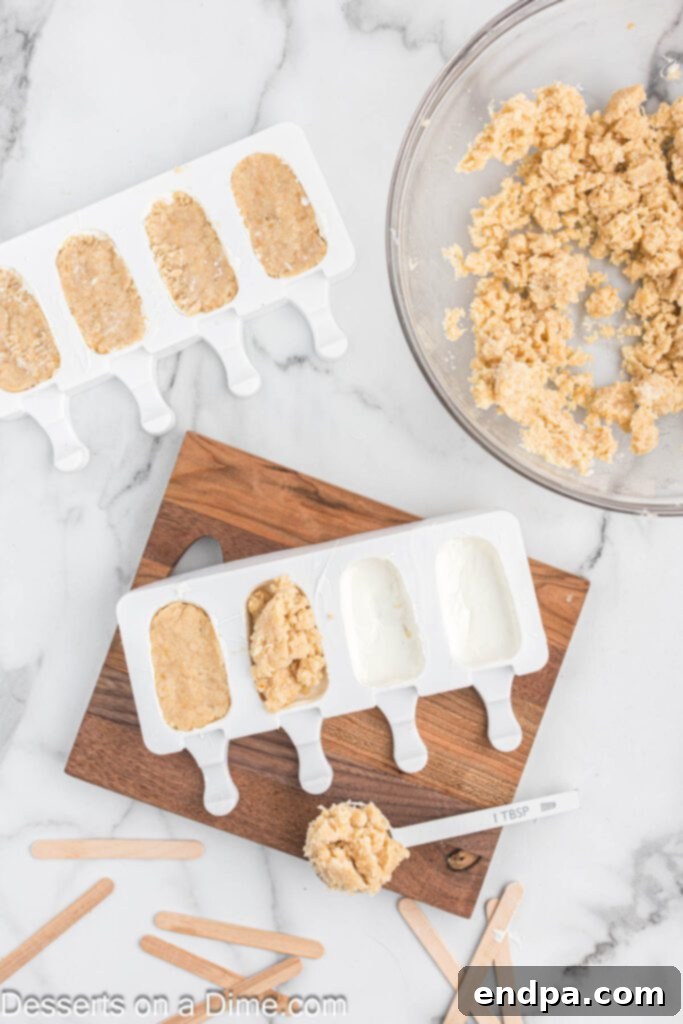 Dessert Pops 7 The cake mixture being pressed into the chocolate-coated popsicle molds.
