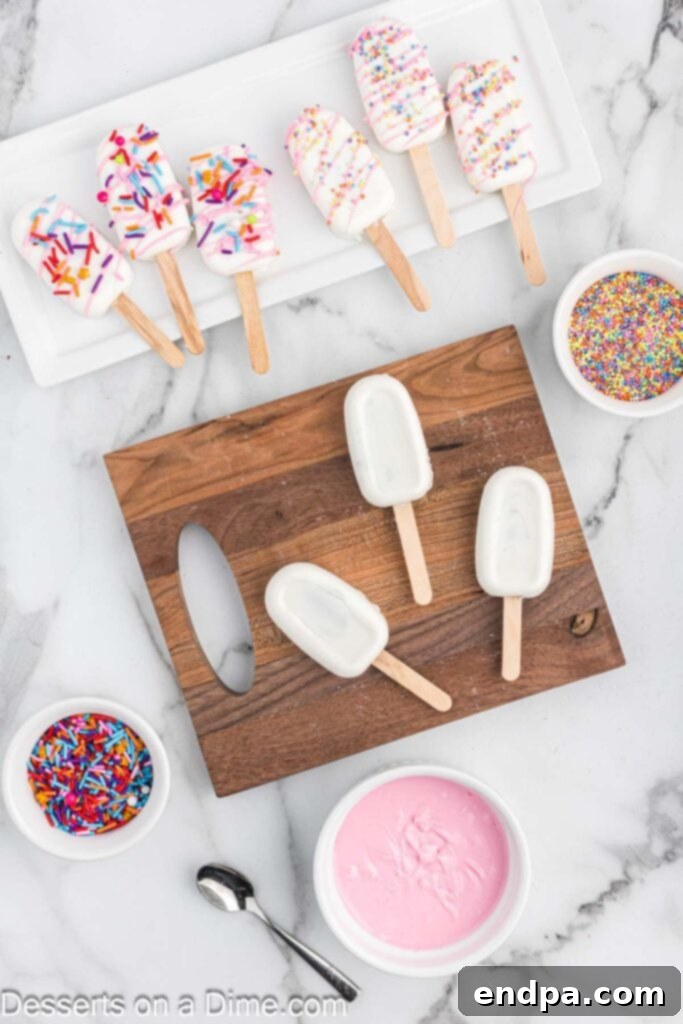 Dessert Pops 10 Finished cakesicles carefully removed from their molds, laid out on a wooden board.